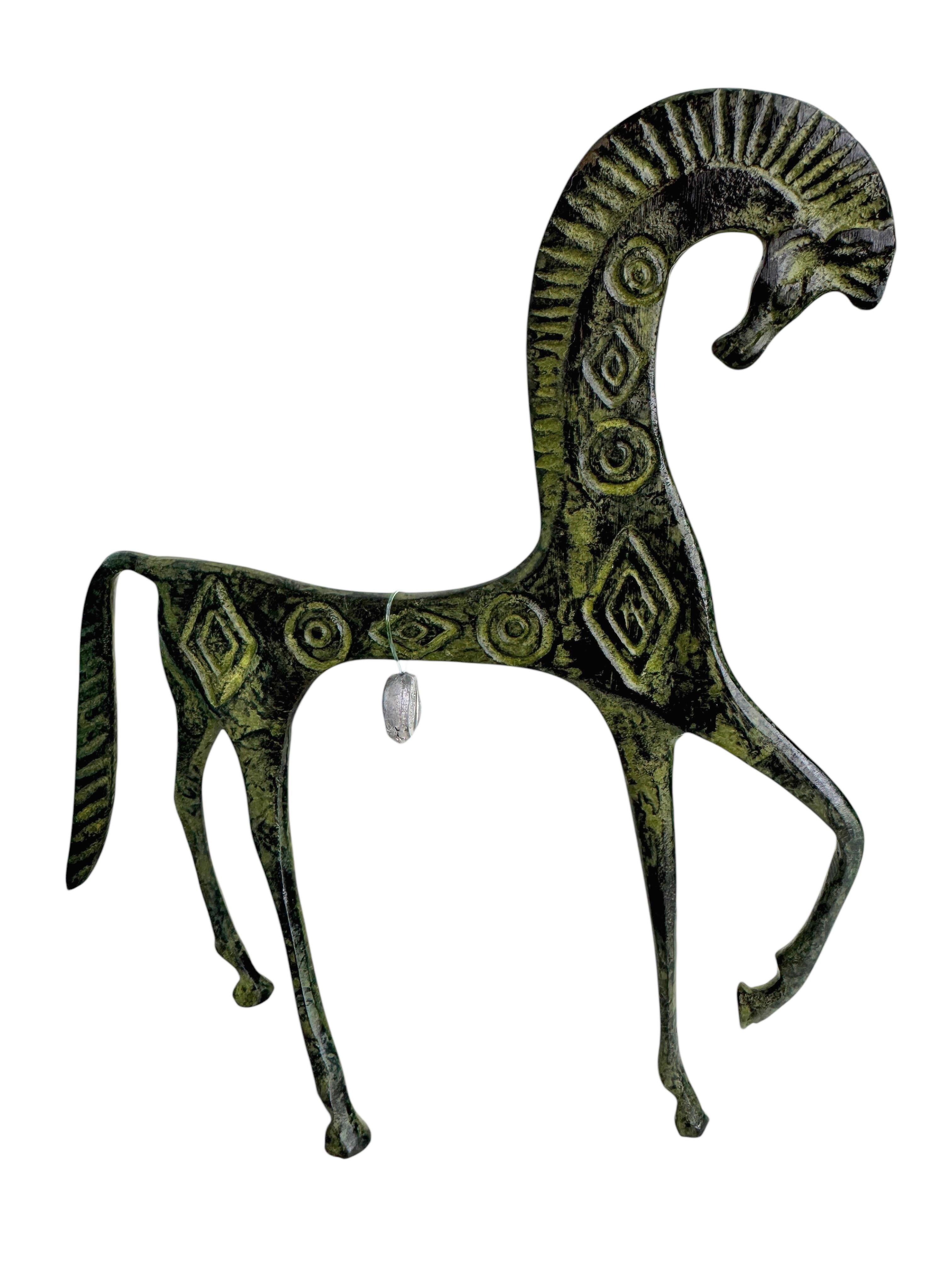 This is a bronze sculpture, in the style of the antique statues and figures of the Etruscans. It is a gorgeous interior furnishing item, an incredibly stylized Etruscan horse and has a patina finish. Greece-made and great for any Mid-Century Modern