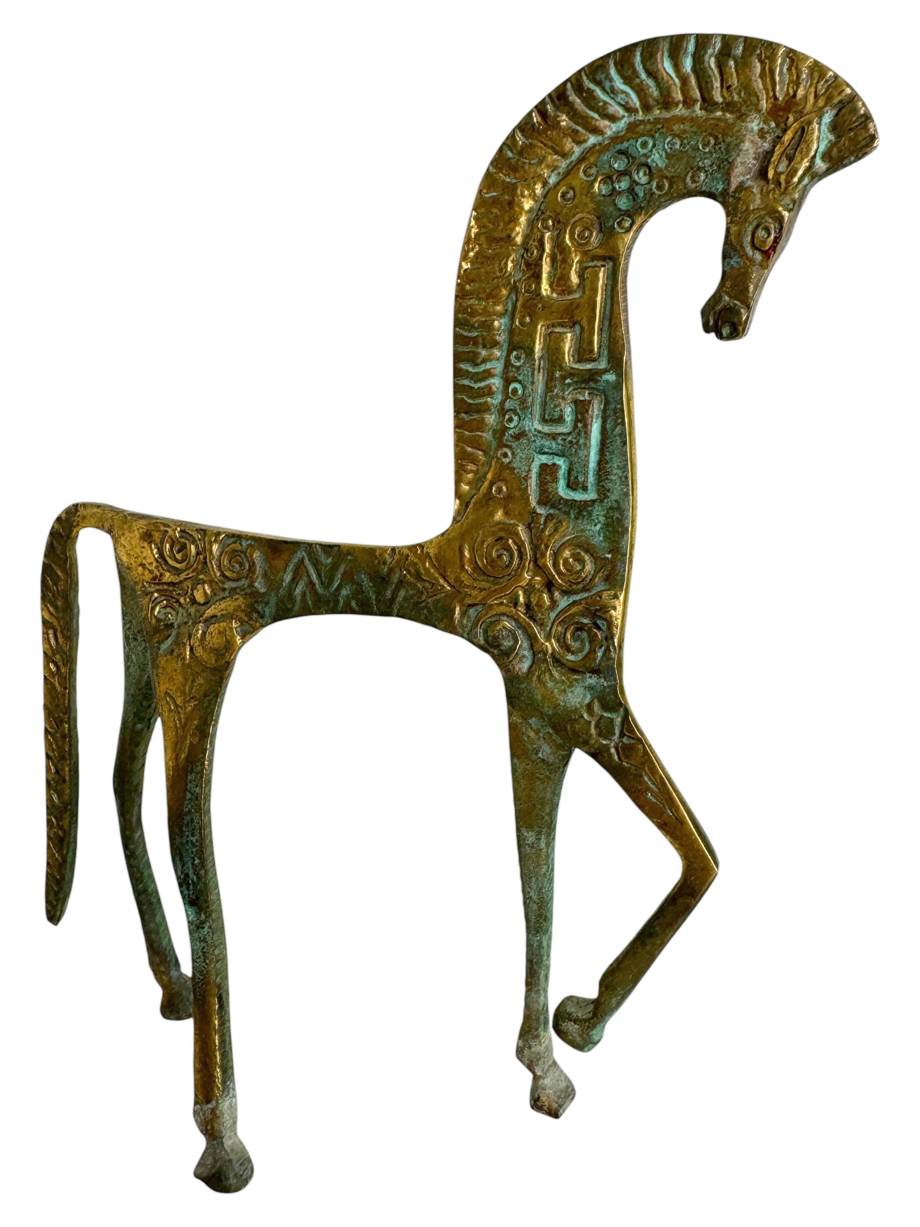 This is a bronze sculpture, in the style of the antique statues and figures of the Etruscans. It is a gorgeous interior furnishing item, an incredibly stylized Etruscan horse and has a patina finish. Italian-made and great for any Mid-Century Modern