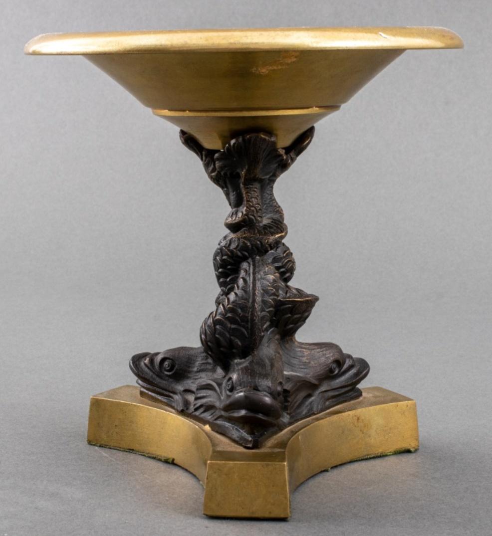 Grand Tour manner tazza with patinated bronze stand in the form of three stylized dolphins, surmounted by a gilt bronze bowl and upon a gilt bronze base. 6.75