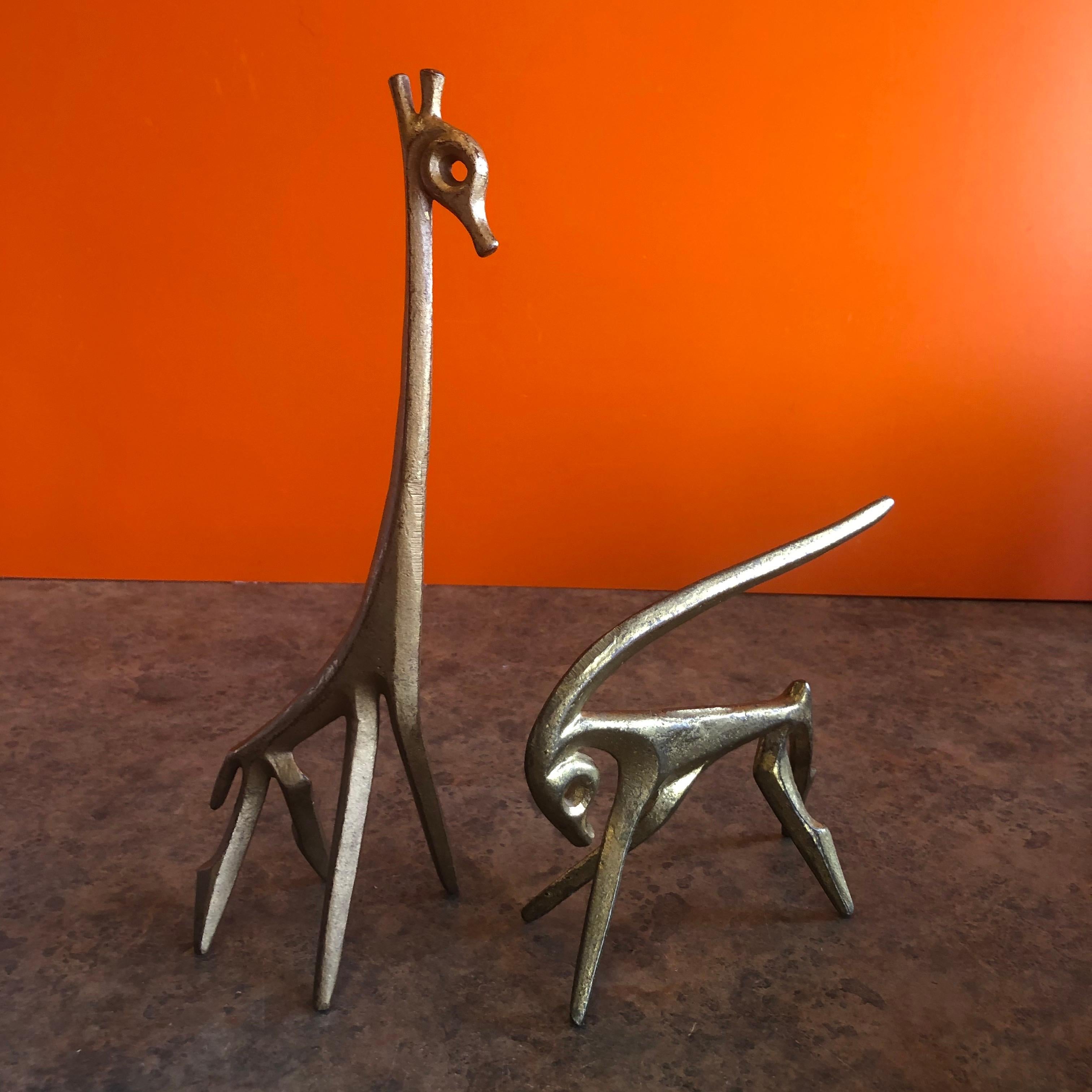 Pair of simple and elegant figurative patinated bronze sculptures of a giraffe and gazelle by Frederic Weinberg, circa 1950s. The Minimalist and modern sculptures have a wonderful vintage patina and are signed 