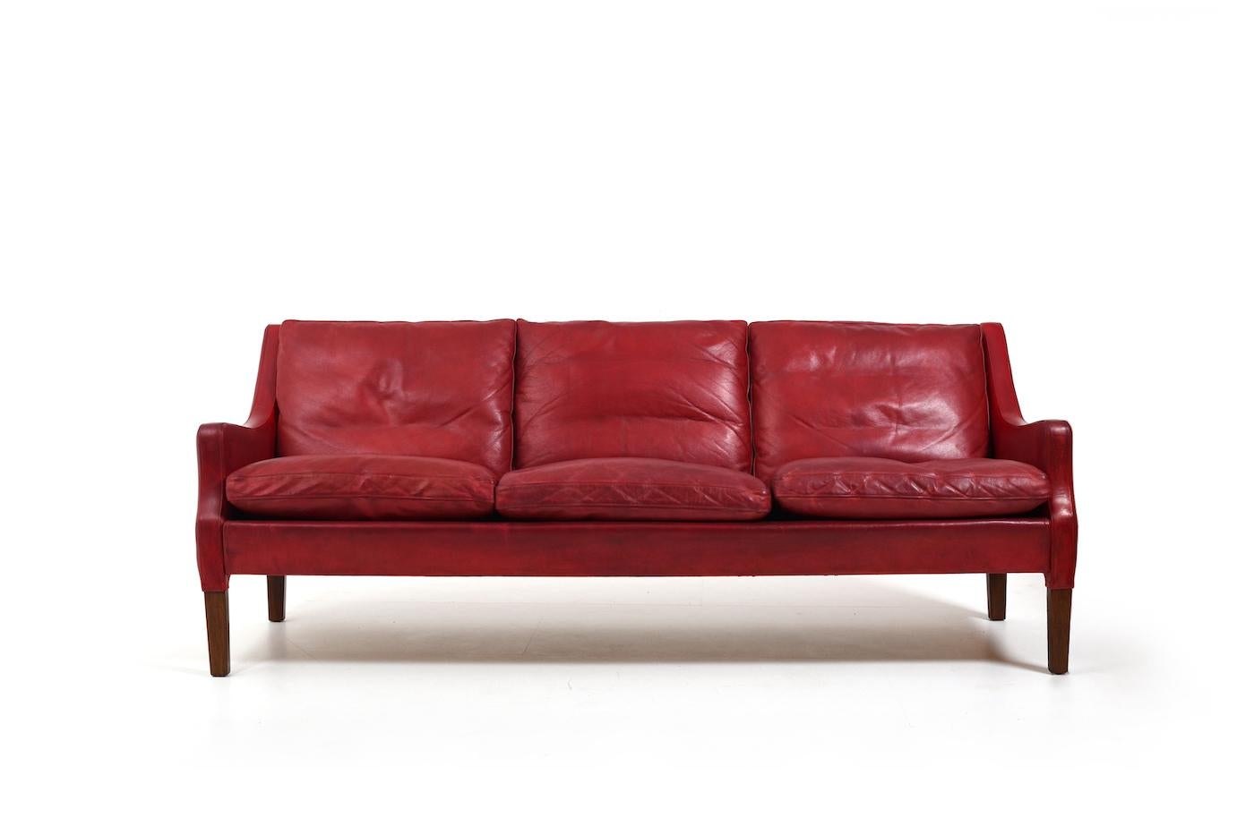 Beautiful patinated „Indian Red“ leather sofa. Designed by Arne Wahl Iversen for own use and been in the family until recently. With teak legs. Denmark 1960s.