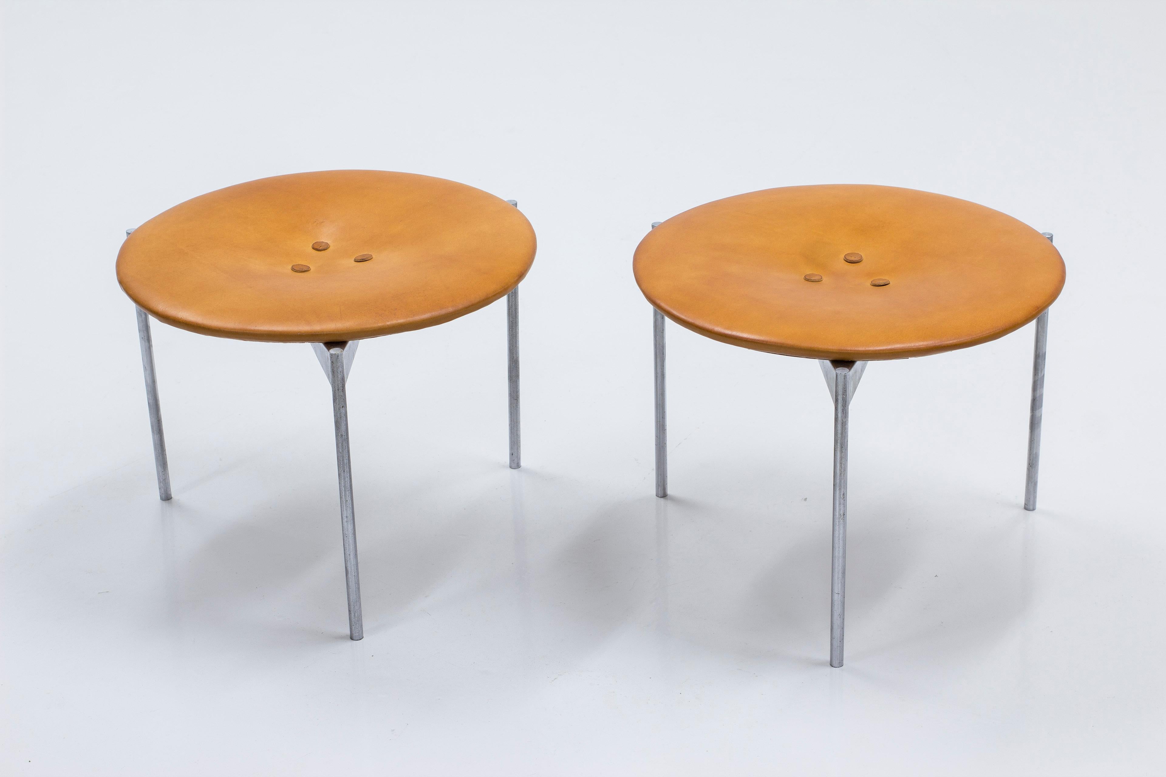 Rare pair of stools designed by Uno & Östen Kristiansson. Produced in Sweden by Luxus during the 1960s. Stainless steel legs and seats reupholstered in cognac leather with a beautiful patina. Very good vintage condition with few signs of wear and