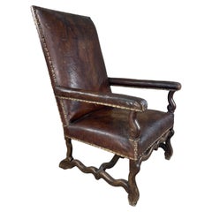 Patinated leather armchair in Louis XIII style