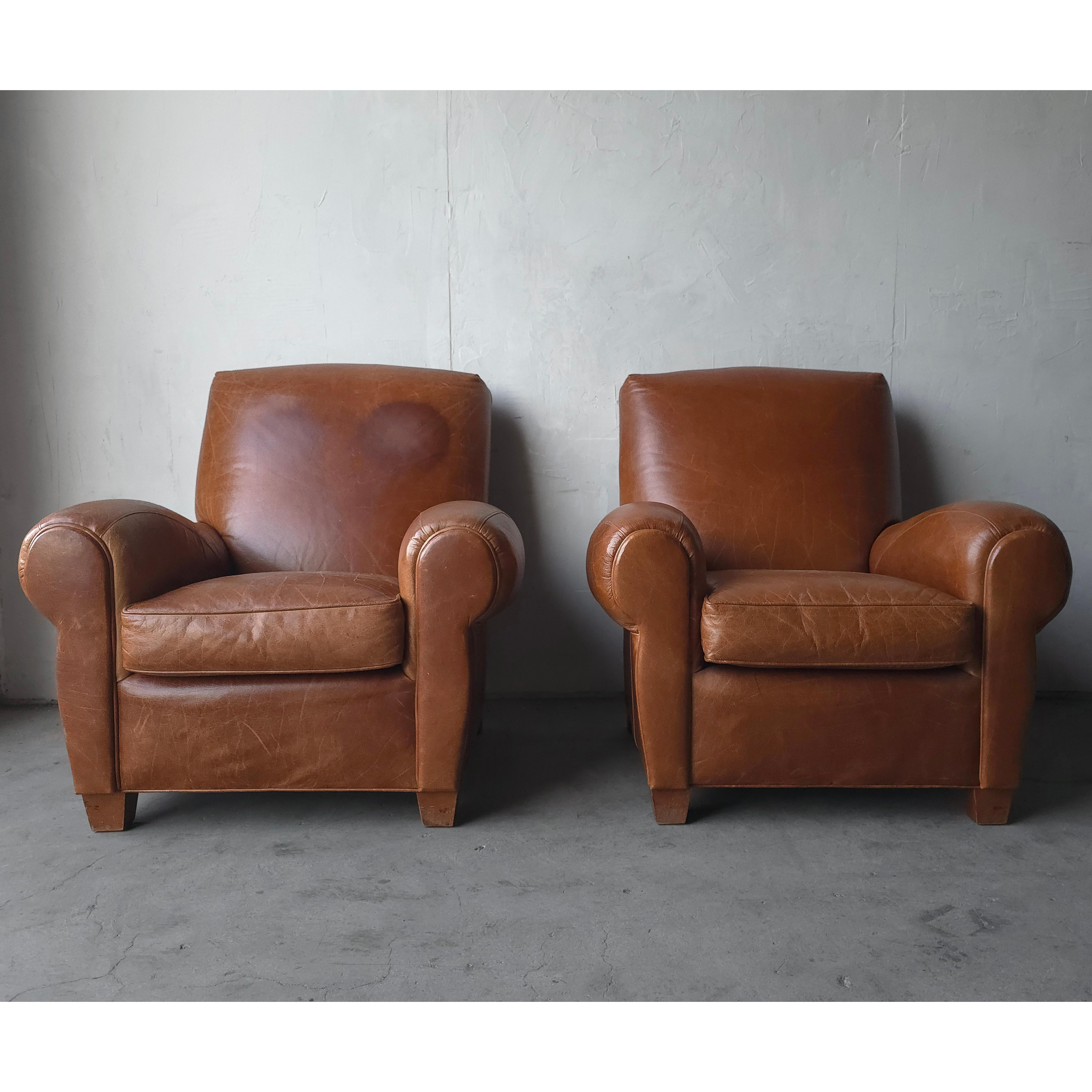 A beautiful pair of properly patinaed leather club chairs. This pair is the epitome of perfect worn leather chairs. Chairs feature the kind of patina that money can't buy, the kind that only comes with use over years. If you've been looking for a