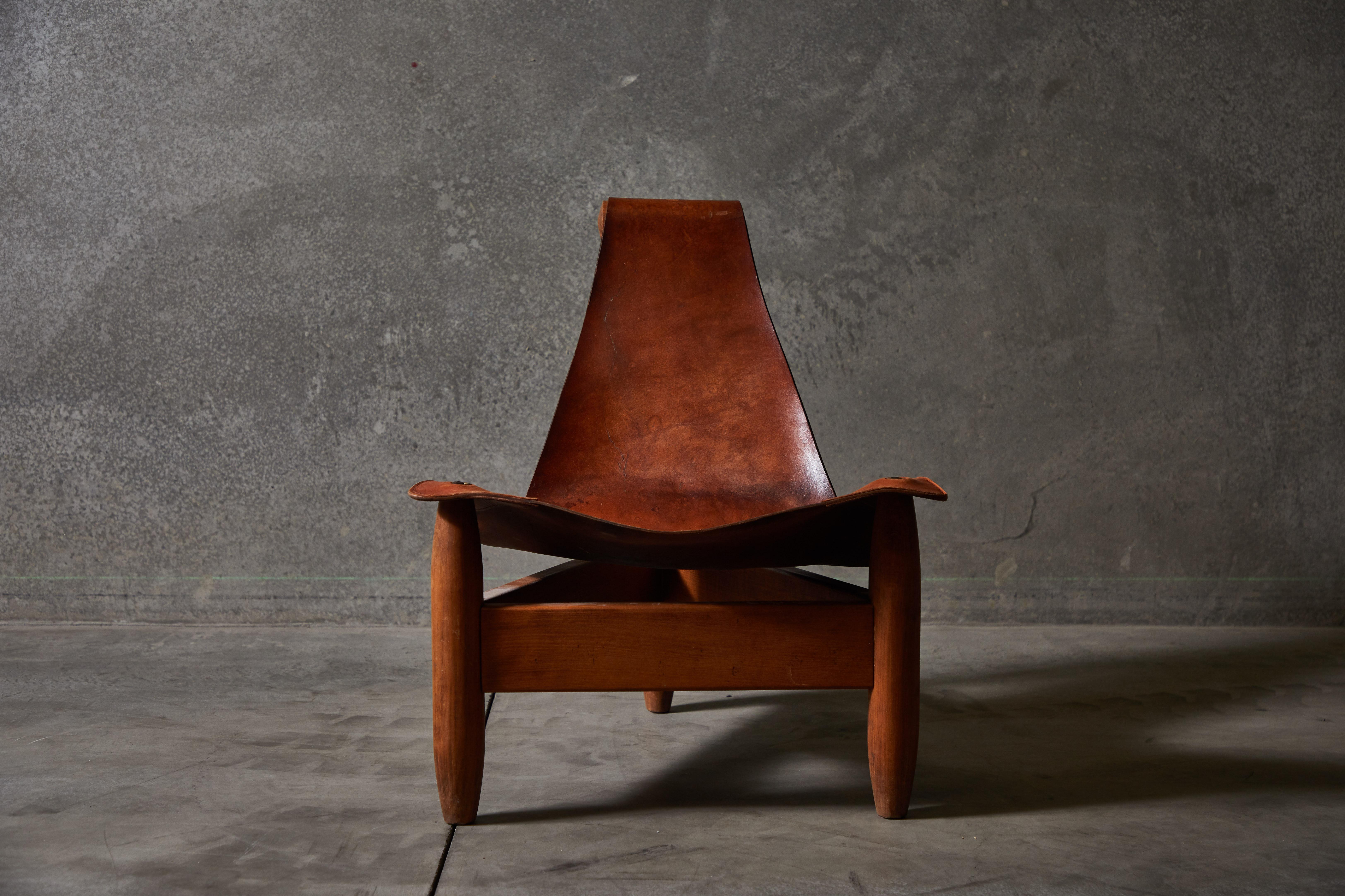 One of a kind patinated tripod cognac leather sling chair. Made in Sweden circa 1960s.