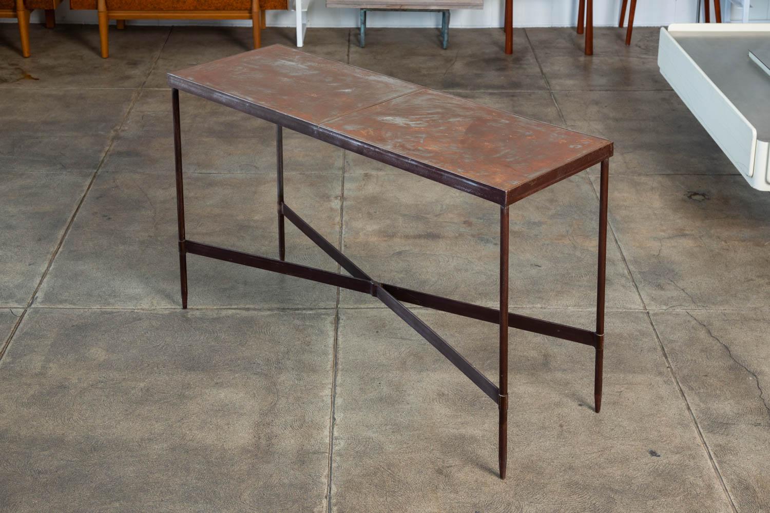 Solid steel console table with great original patina. The table features a narrow rectangular top that sits atop thin solid metal legs and “X” shaped stretcher bars.

Condition: Good vintage condition.

Dimensions: 48” width x 16.25” depth x