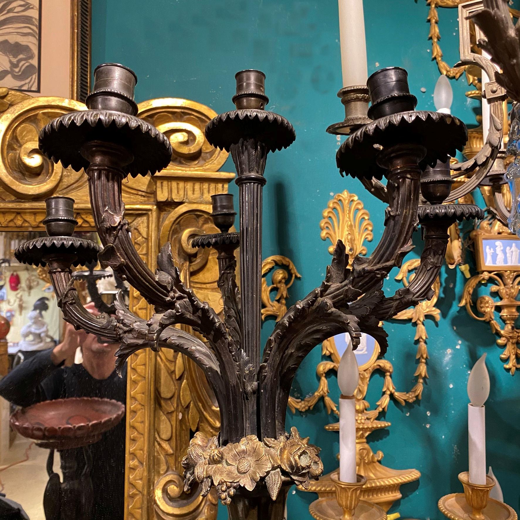 Patinated neoclassical figural candelabra after Claude Michel, aka Clodion.