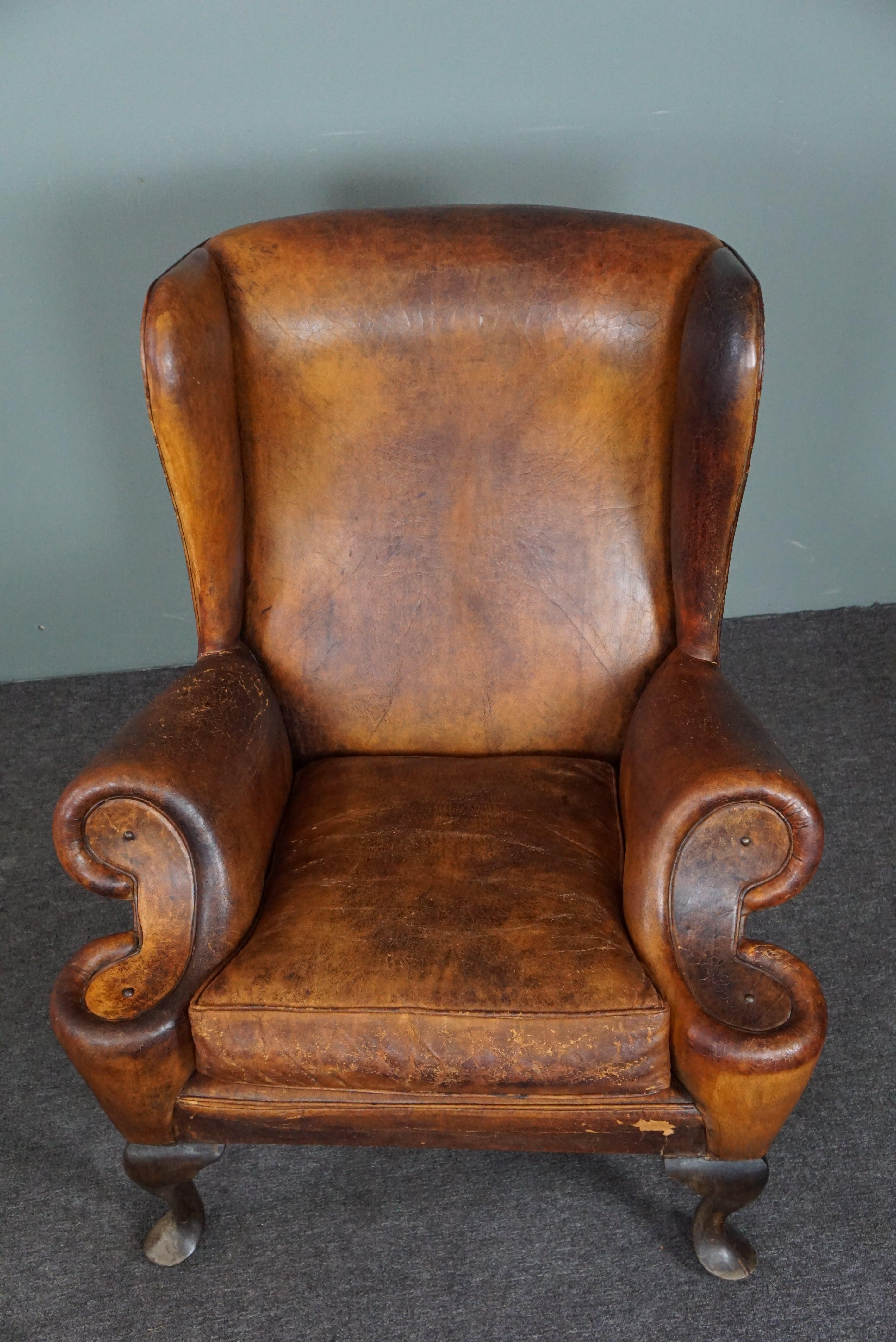 Patinated sheepskin antique Wingback wingback armchair In Distressed Condition For Sale In Harderwijk, NL