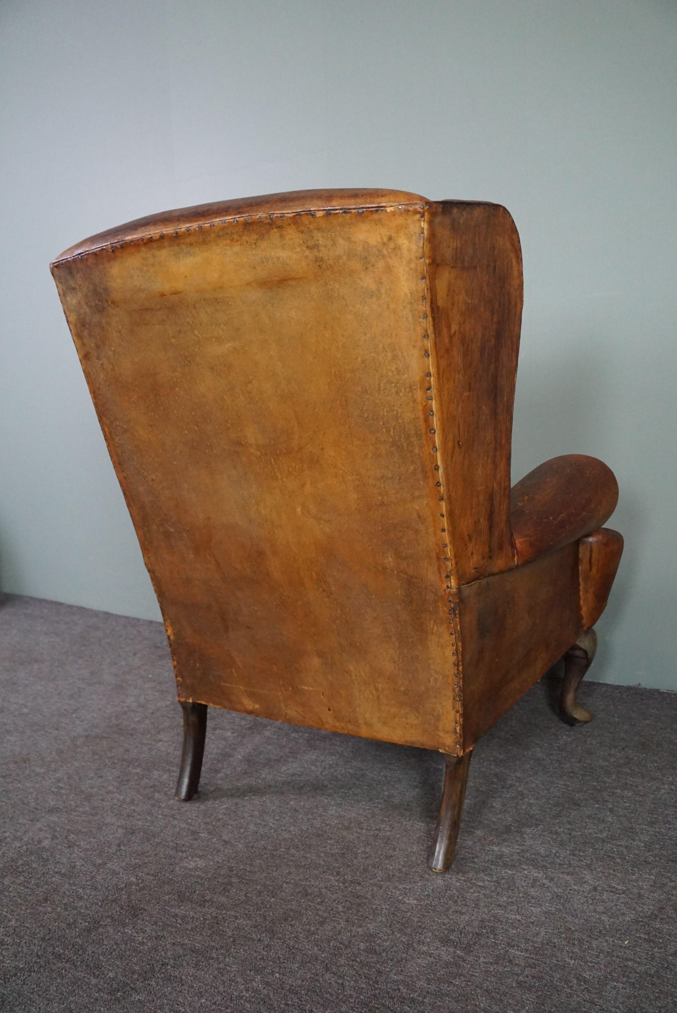 20th Century Patinated sheepskin antique Wingback wingback armchair For Sale