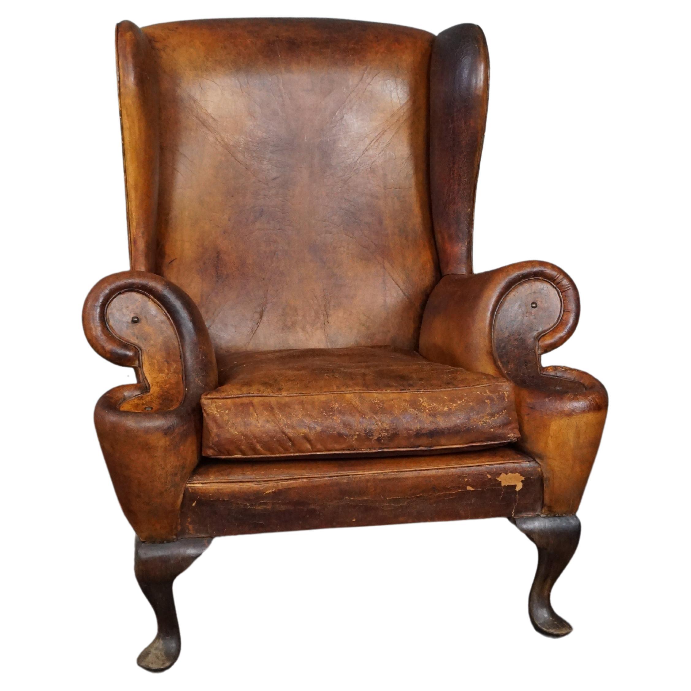 Patinated sheepskin antique Wingback wingback armchair For Sale