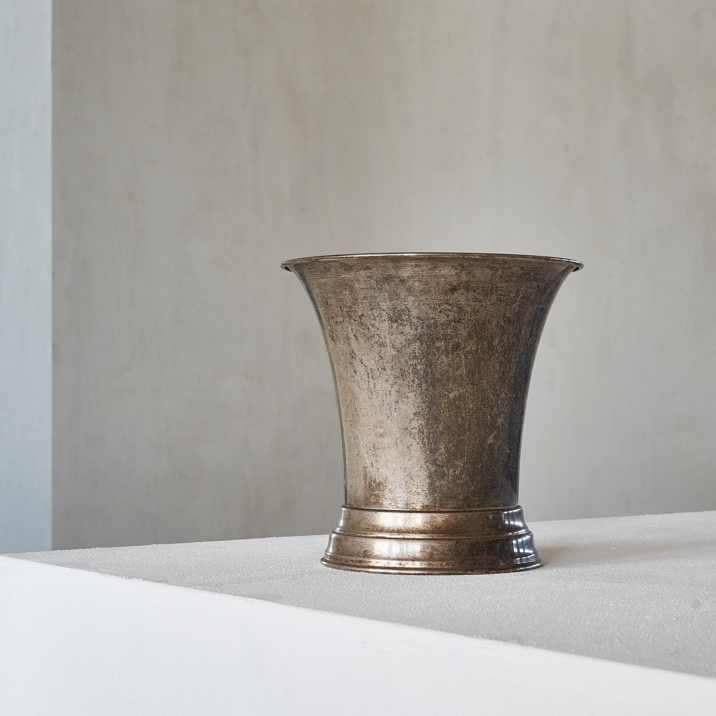 Sometimes all is needed is a simple but refined shape and some nice patination. This beautifully patinated silver plated wine cooler or vase is a piece of beauty and elegance. 

It can be used as a wine cooler, as a vase or just as a fantastic