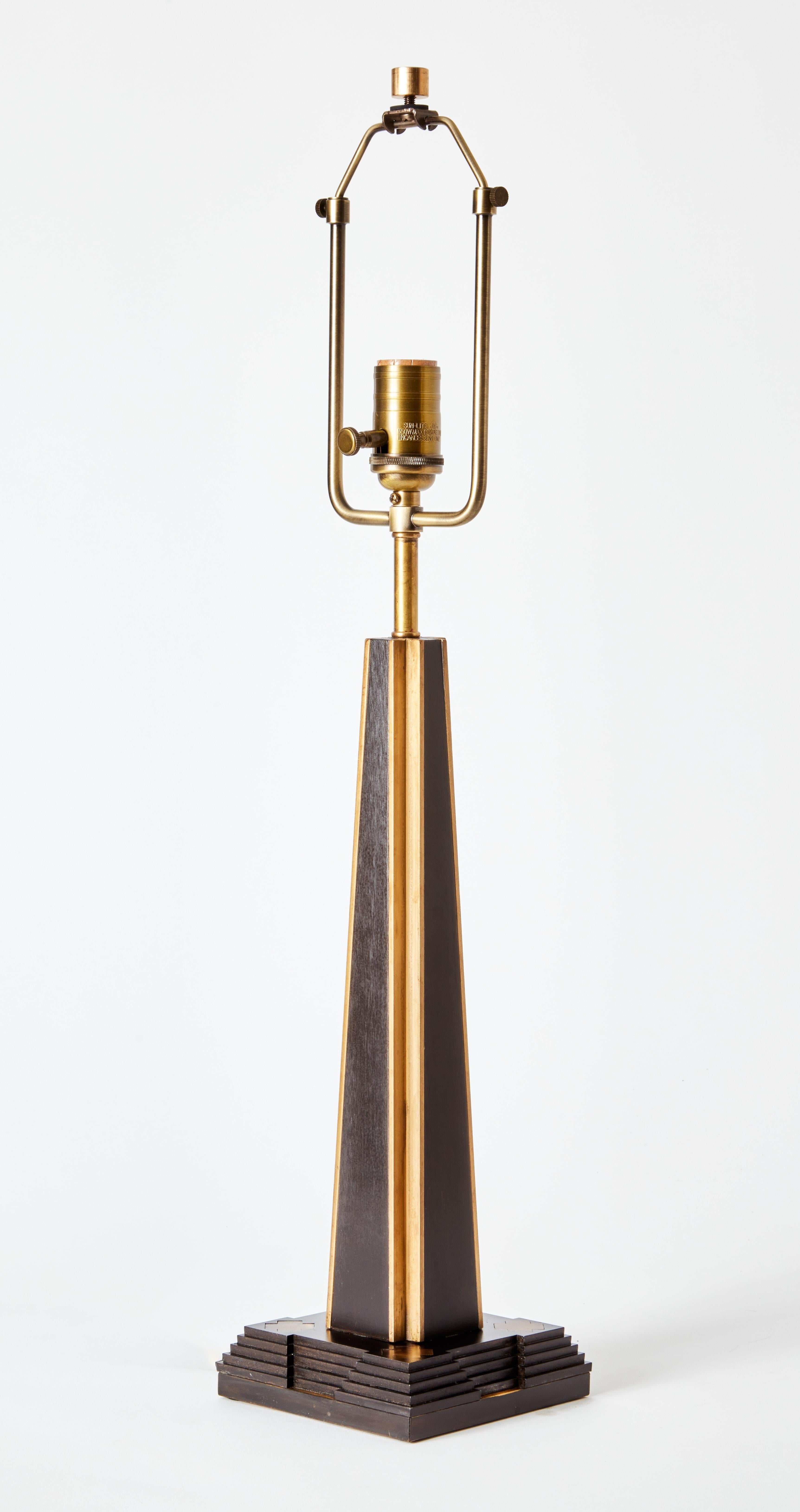 A table lamp in pyramid form – set on a fluctuating, stepped base. The design references the architecture of mesoamerica as well as inspirations from the neo-andean and art deco movements.

The brass detailing has been lightly antiqued while the