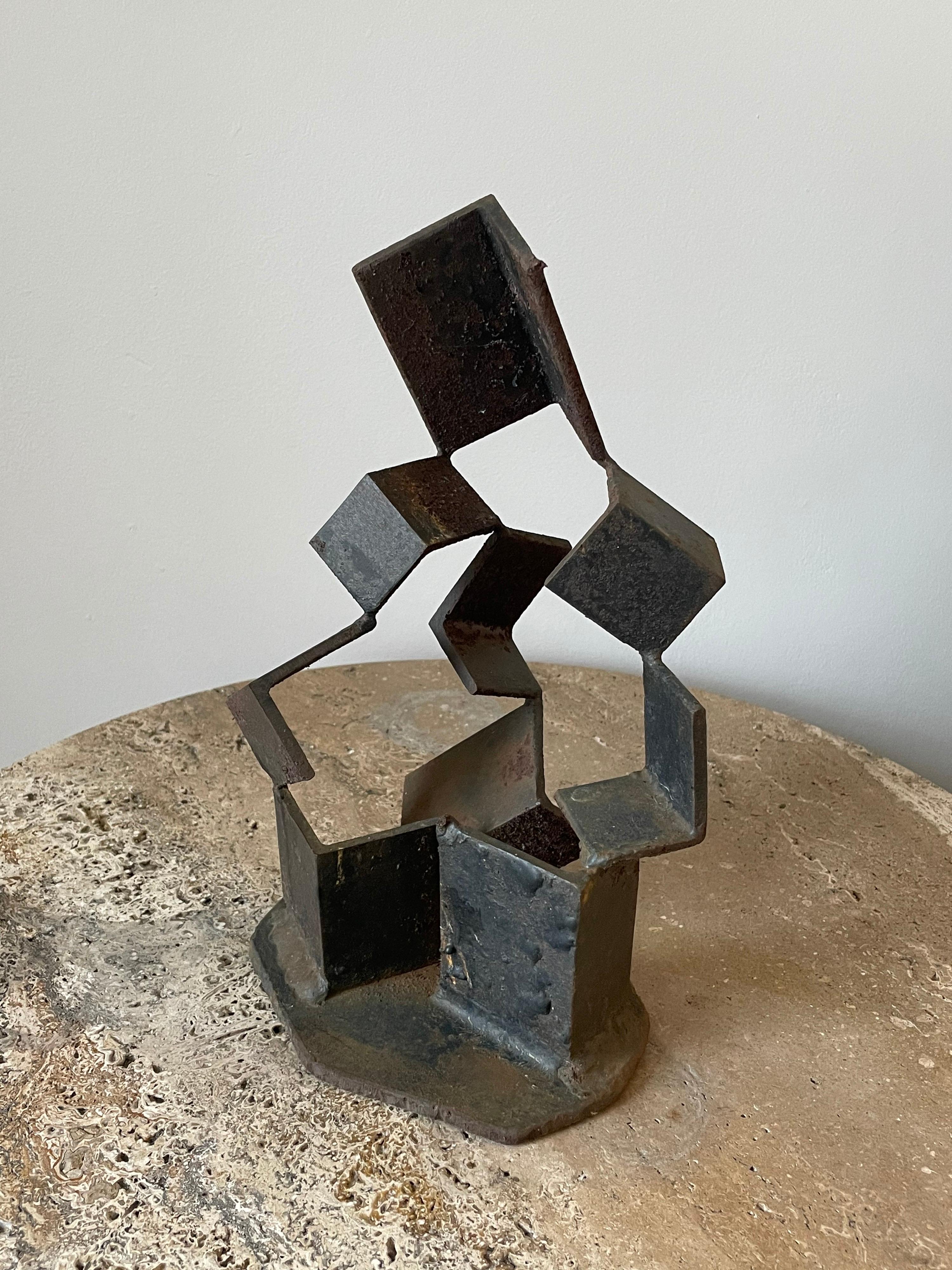 Unusual welded steel sculpture which consists of multiple pieces attached at the corners producing a floating appearance.