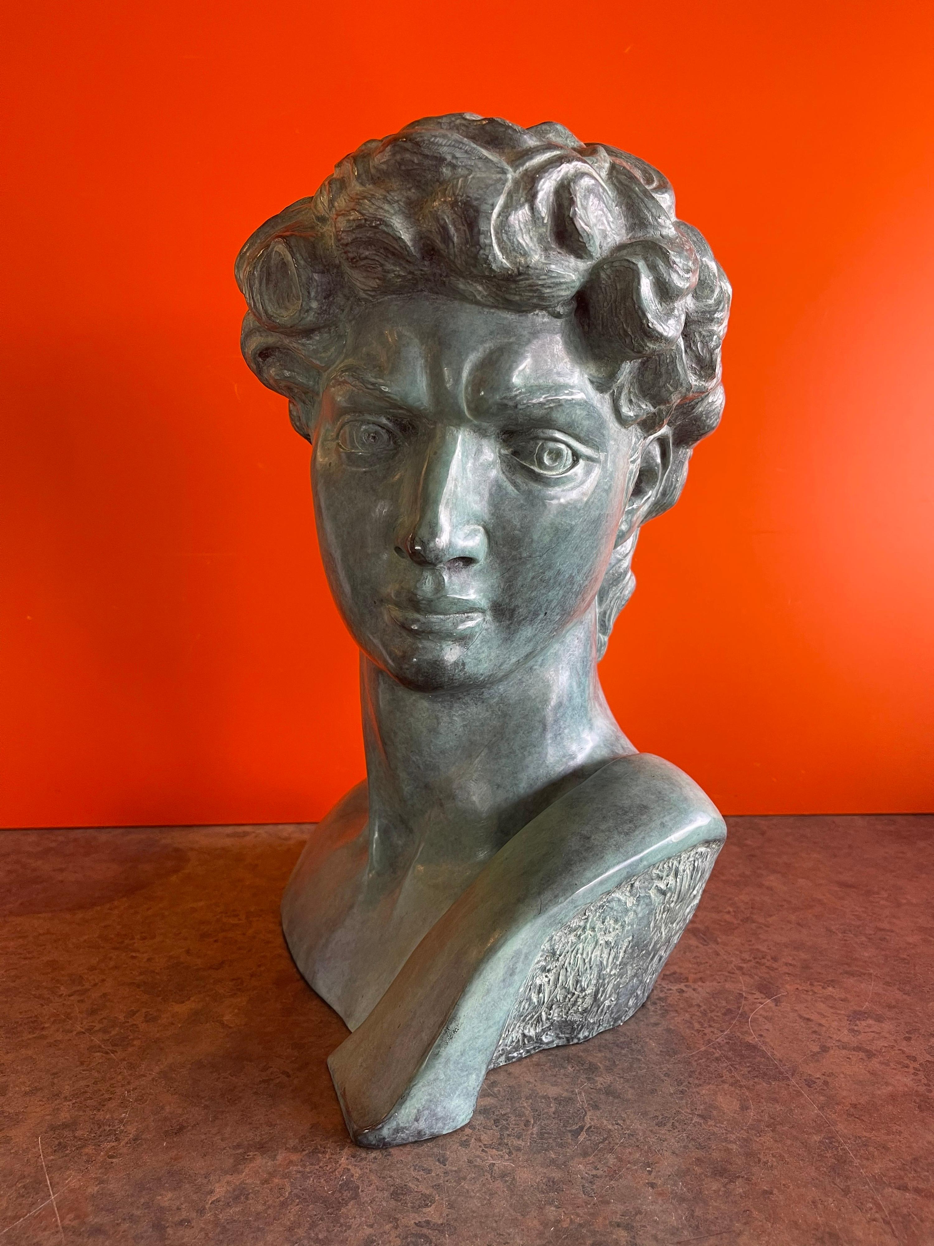 A very nice patinated verdigris bronze bust of Michelangelo's David by Felix de Weldon, circa 1993. The piece is signed and dated by the artist and marked 6 / 25 AP; it is in very good condition and makes a wonderful statement in any room! #1532.