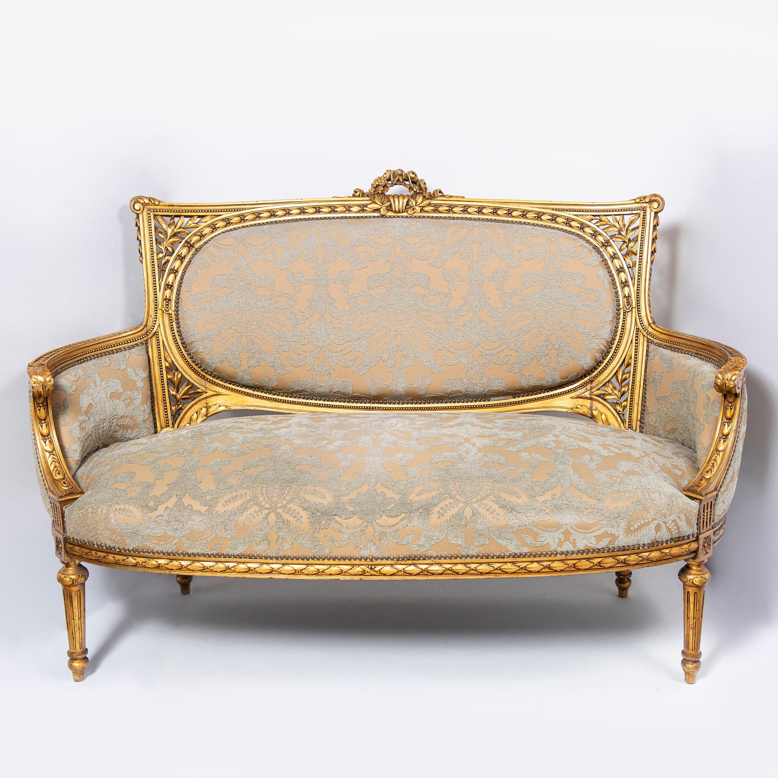 Patinated wood and gold leaf seven pieces suit. Attributed to Maison Jansen, France, late 19th century.
One large sofa, two armchairs and four chairs.

Dimensions: 
Large sofa: 106 cm height, 153 cm width, 80 cm depth, 59 cm seat height. 
Armchairs: