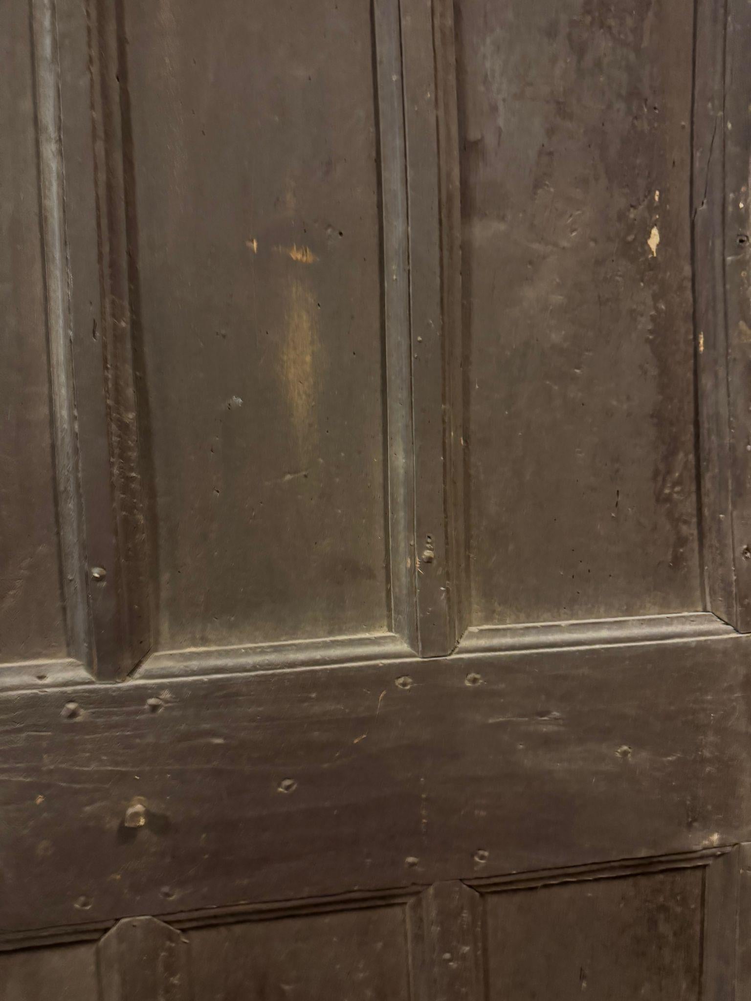Antique entrance door, solid wood main door with a contemporary patinated finish, carved with six panels, a smooth back with irons for direct wall mounting and a contemporary lock, original from the early 19th century and sourced from Italy. Maximum