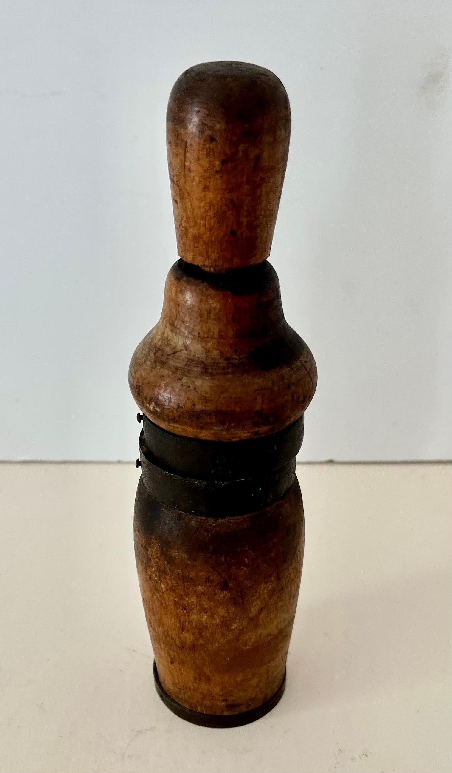 I rarely purchase pieces that I don't know the purpose of, but this piece was purchased with some wine accessories. it's a beautiful piece and while it looks like a pepper mill, it definitely is not.

One theory is one puts their wine cork into