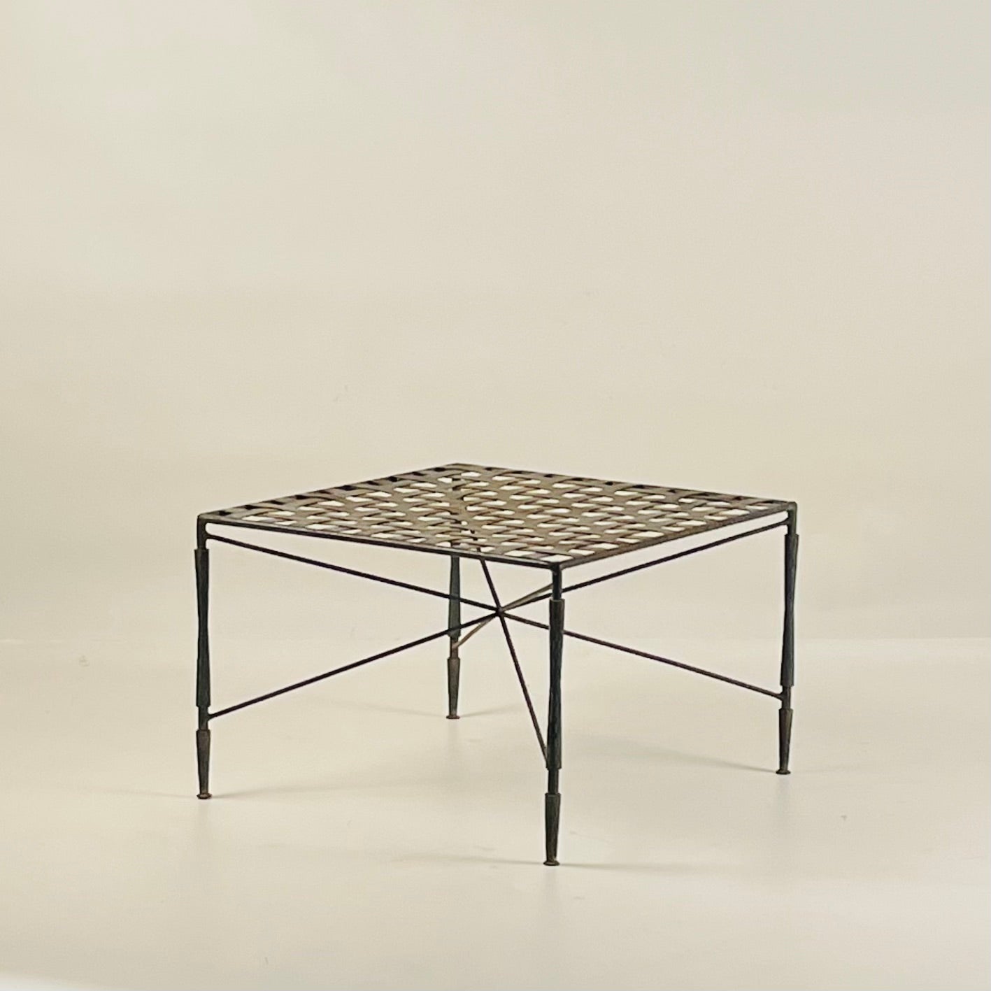 Patinated wrought iron outdoor ottoman designed by Mario Papperzini for John Salterini. Wonderful verdigris green original finish.

16 or 17 in. seat height with 2 or 3 in. thick cushion (not included).

Can also be used as a side table or small