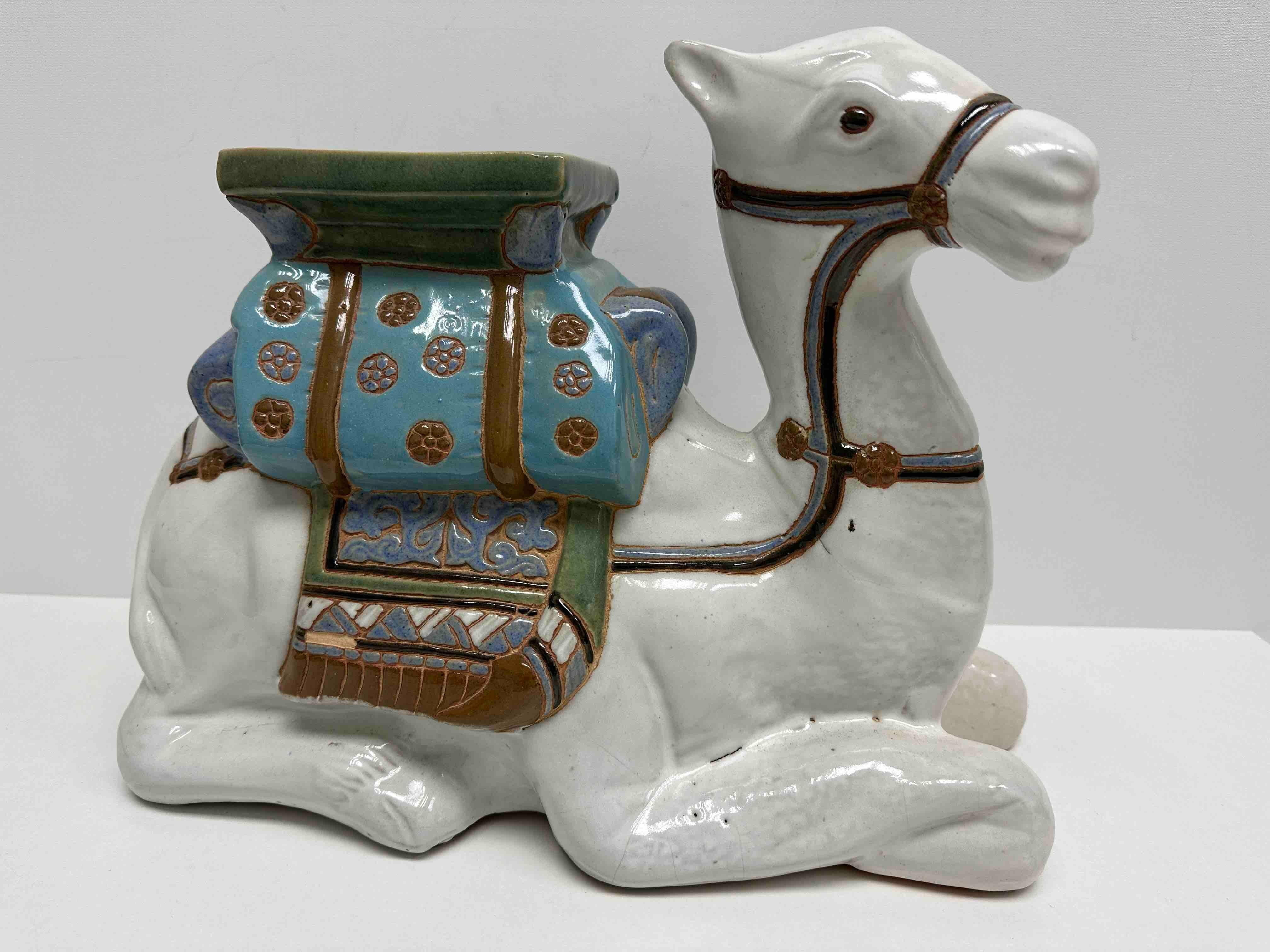Mid-20th century glazed ceramic camel garden flower pot stand. Handcrafted ceramic. Nice addition to your home, patio or garden area. Seat height is approx. 10.25 inches.
 