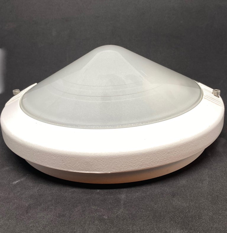 A beautiful outdoor sconce or flushmount made in the 1980s by RZB Leuchten, in very good original condition. The frosted glass is composed of a white aluminum frame and with one light. The fixture requires one European E27 / 110 Volt Edison bulb, up