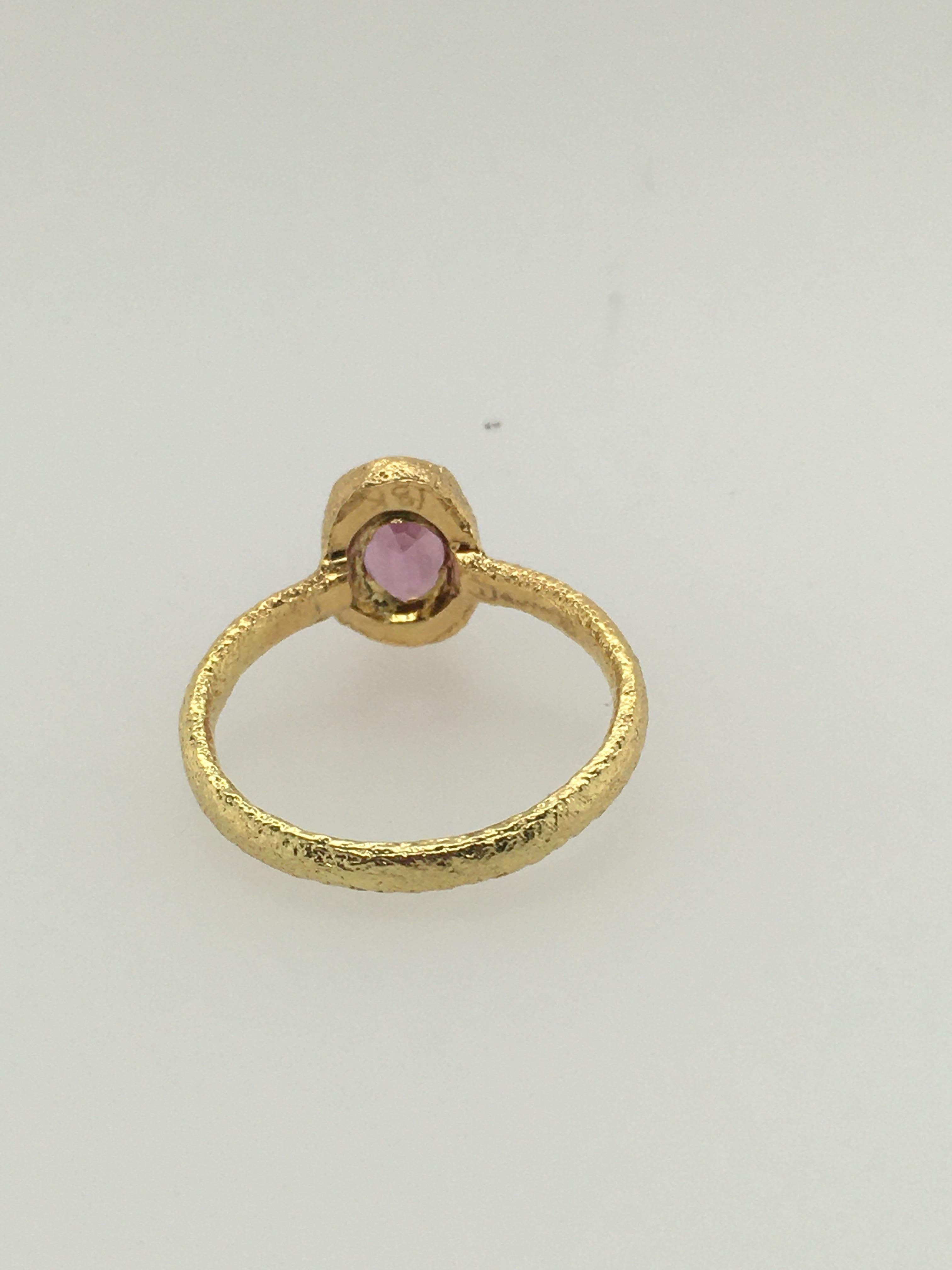Distinctive, hammered 18K Yellow Gold Ring with oval Rose Pink Rhodolite Garnet.  Designed & created by well-known Maine jeweler Patricia Daunis, in her Portland studio.  Part of her custom 18K Yellow Gold ATUIK collection, this ring stacks