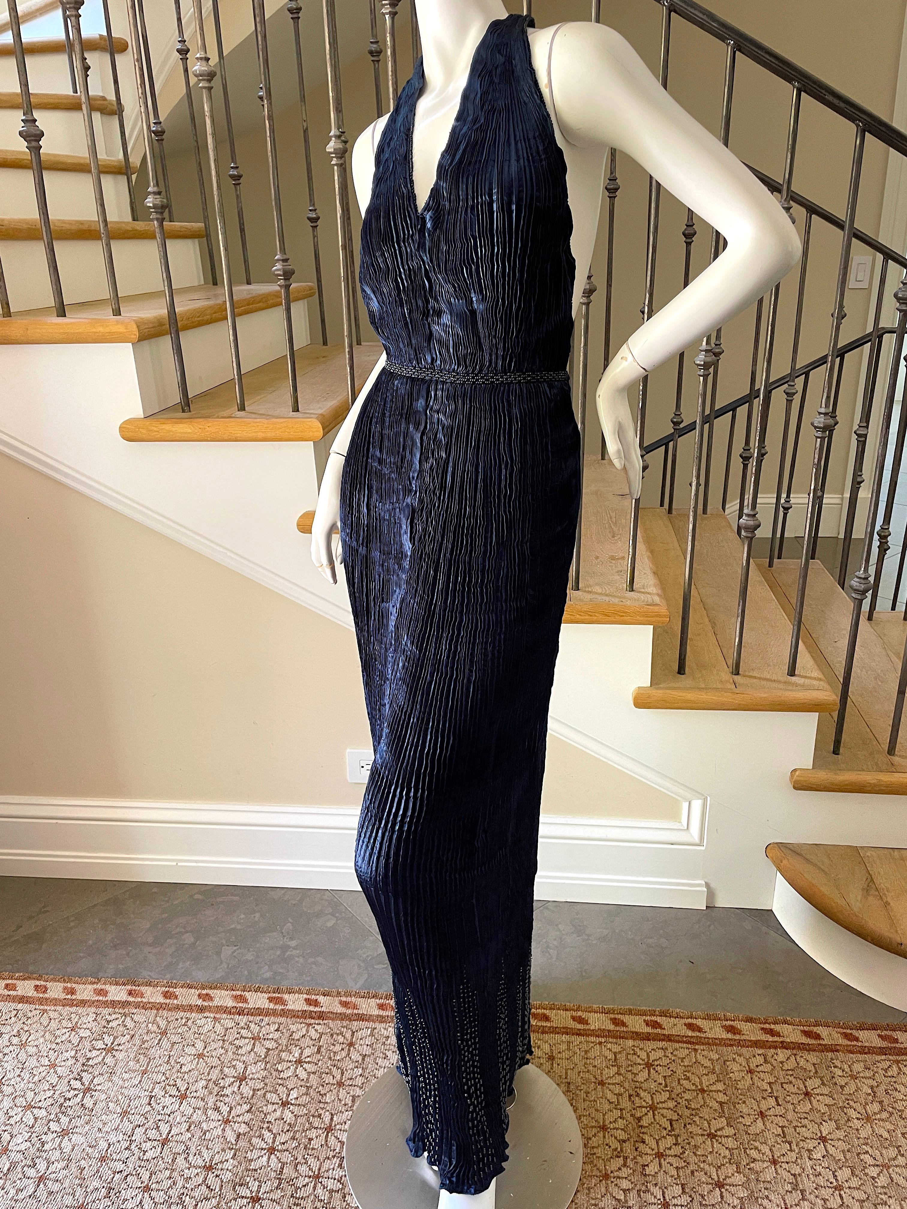 Patricia Lester Wales Fortuny Style Plisse Pleated Indigo Blue Bead Halter Dress.
Created painstakingly by hand in Wales, this is plisse pleated in the style made famous by Mario Fortuny.
Accented by deep blue beading, this was sold at Bergdorf