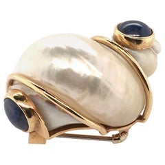 Patricia Schepps Vail for Seaman Schepps Shell, Gold and Sapphire Brooch