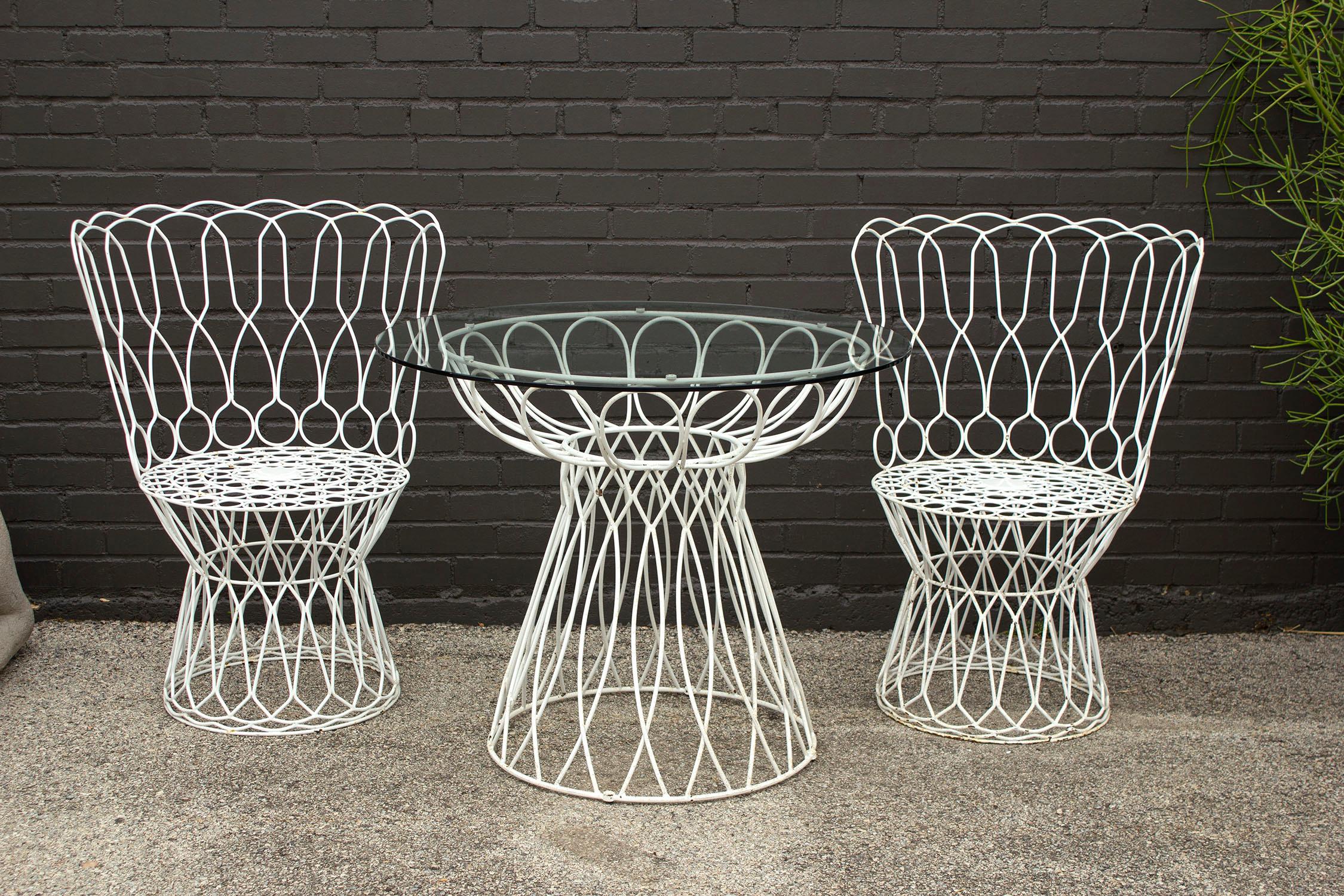 Patricia Urquiola Re-Trouve wire patio table and chairs set for EMU, Italy. Can be powder-coated to the color of your choice prior to shipping. Includes 2 seat cushions.

Chairs measure 35