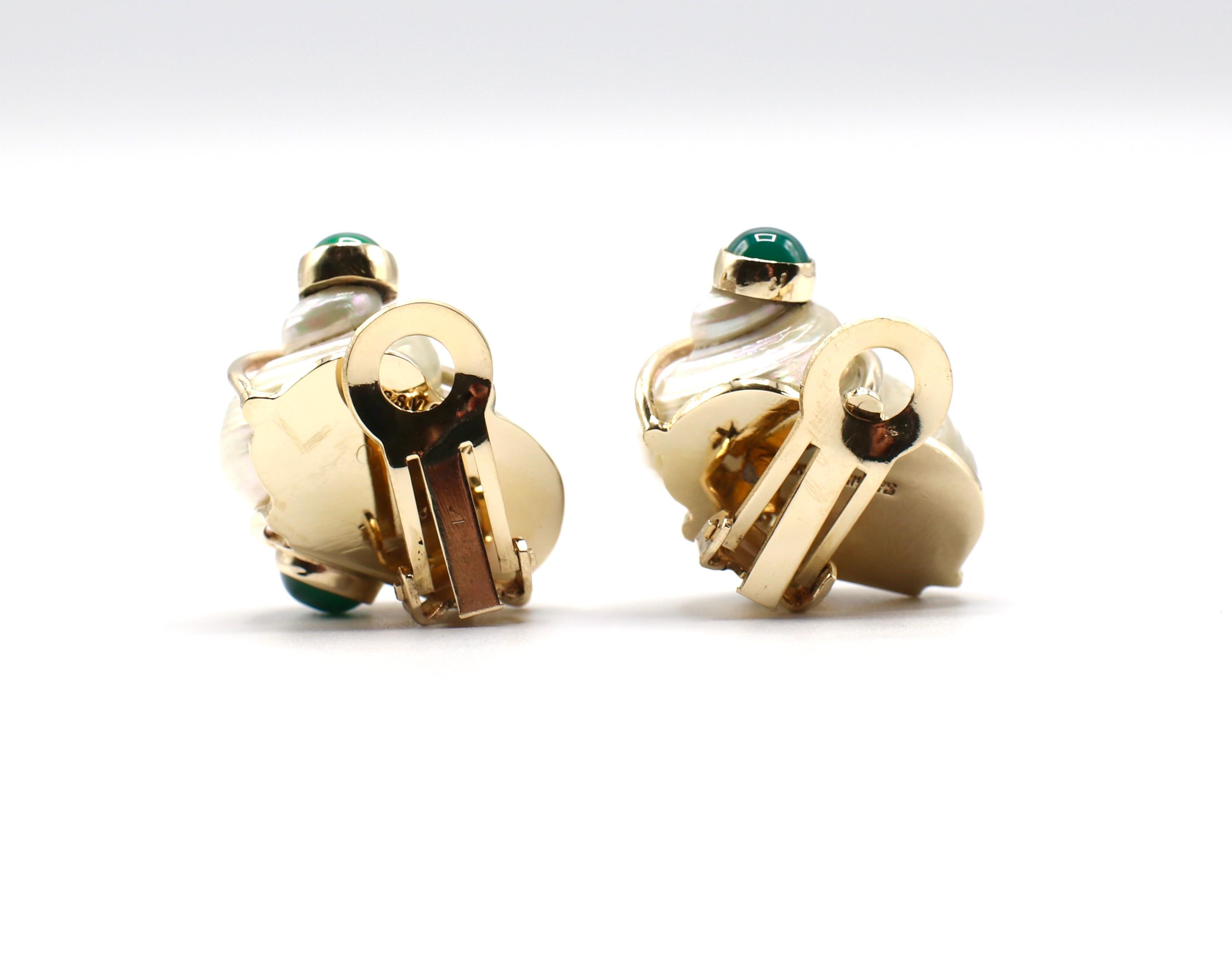 Vintage Seaman Schepps 1960's Turbo Shell Patricia Vail Earrings 14K Yellow Gold & Green Chalcedony

Metal: 14k yellow gold
Signed: P.S.V of Seaman Schepps 
4 dyed green chalcedony cabochon stones, 5.5mm each
Earrings are approx. 1 inch long
Shell