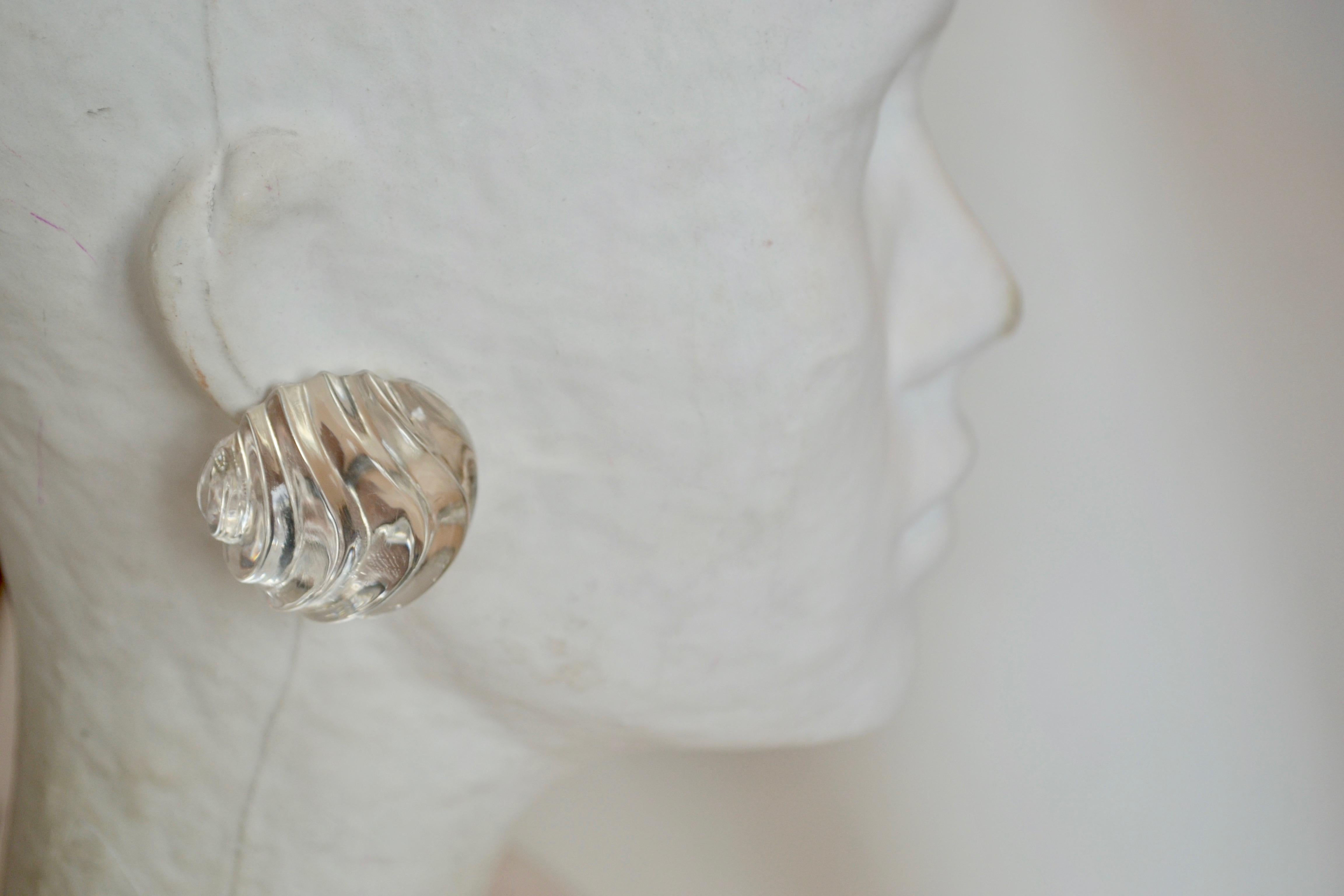 Round large carved disc lucite clip earrings with sterling silver backing from Patricia von Musulin. 