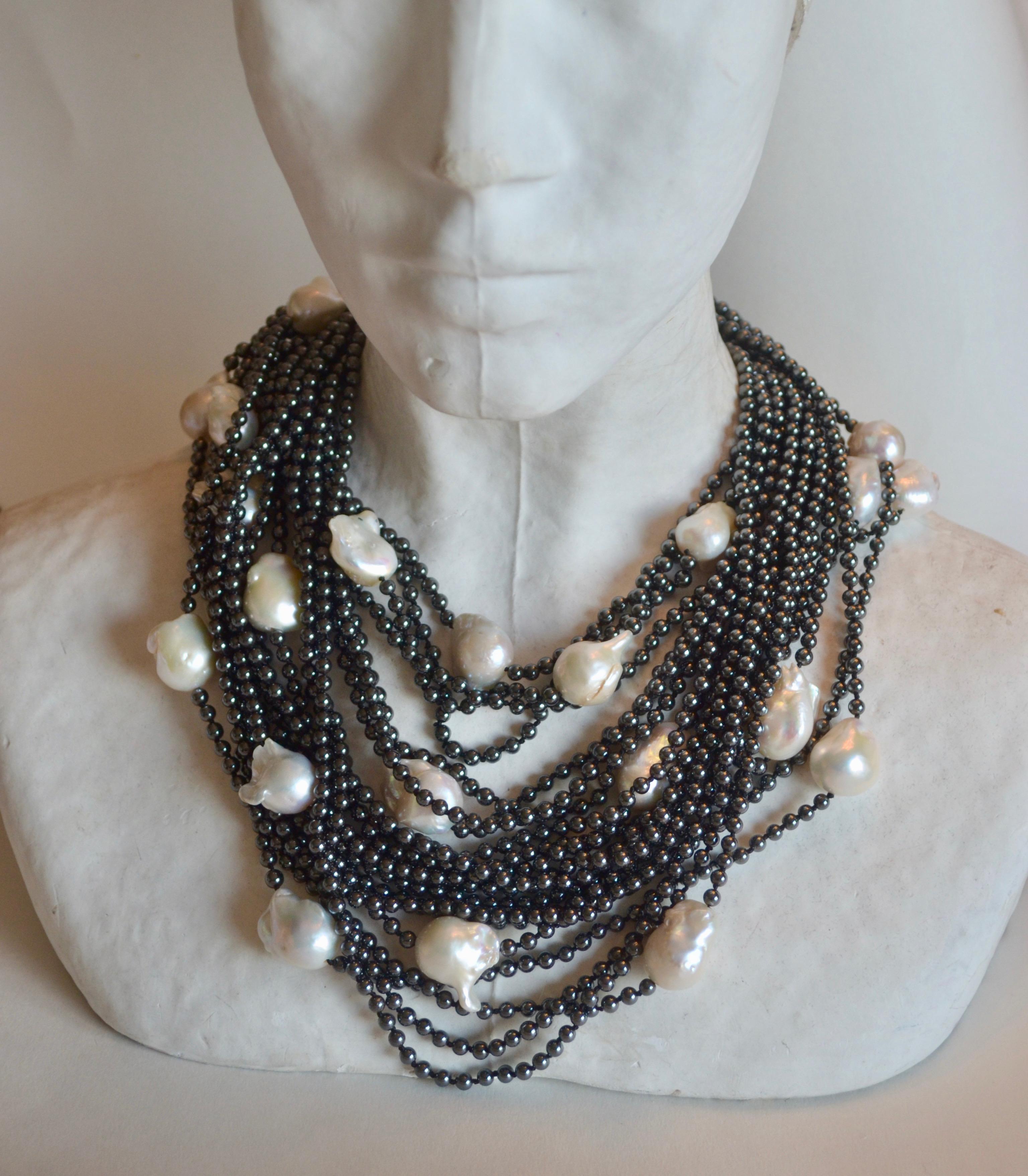 Small round hematite bead and large white baroque pearl 20 strand necklace with sterling silver round clasp from Patricia von Musulin. 