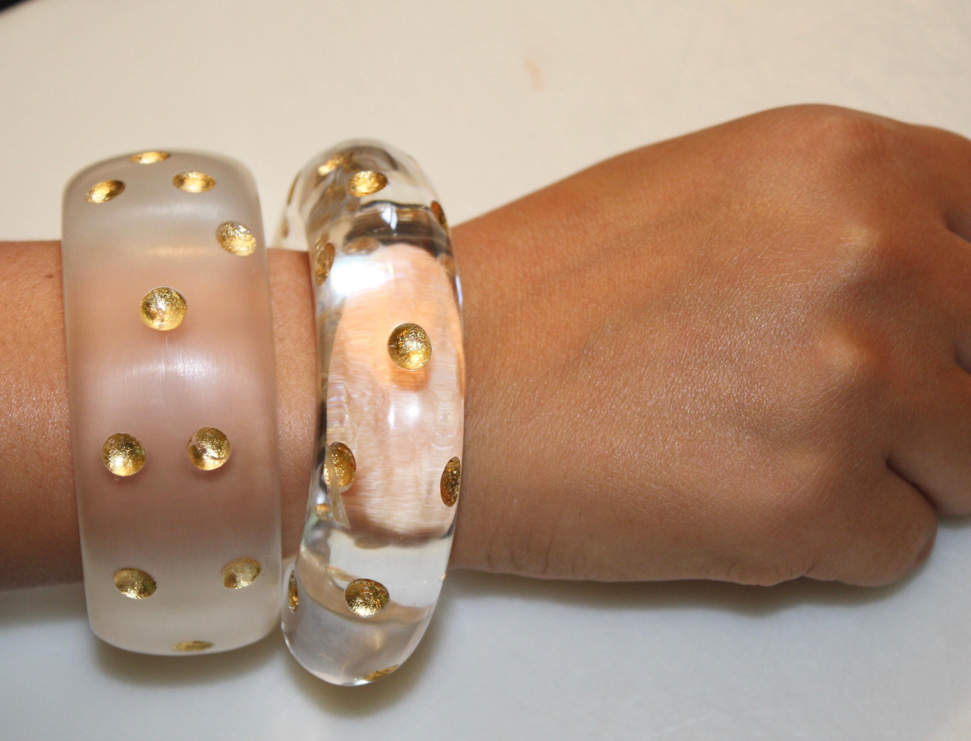 Open ended bangle in hand carved lucite with 24kt gold polka dots from famed designer Patricia von Musulin. 

6