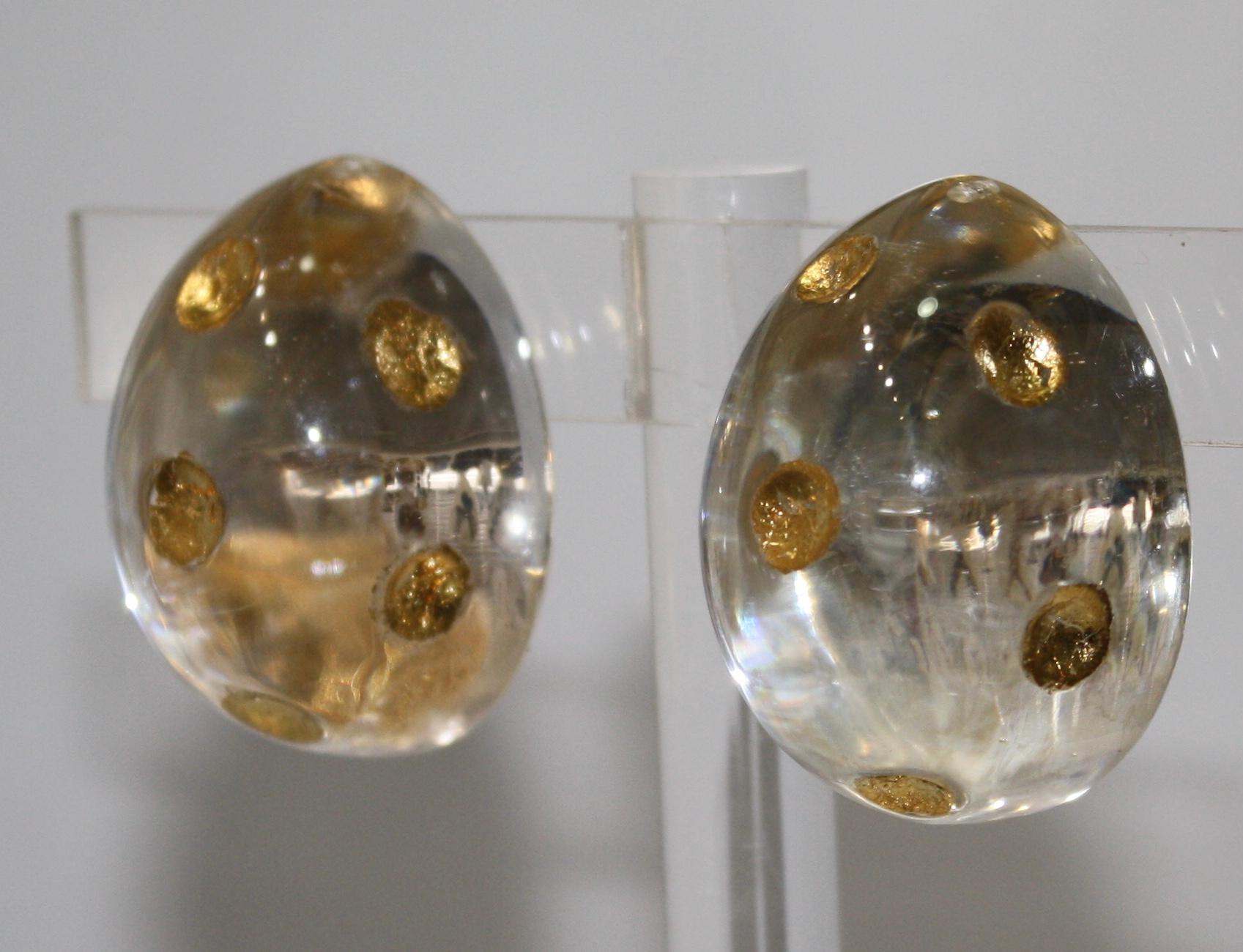 Lucite half ball with 24Kt gold dots and sterling silver back clip earrings. The silver gives a bright reflection of light on your ears. Limited series.
Signature on the back of the earrings