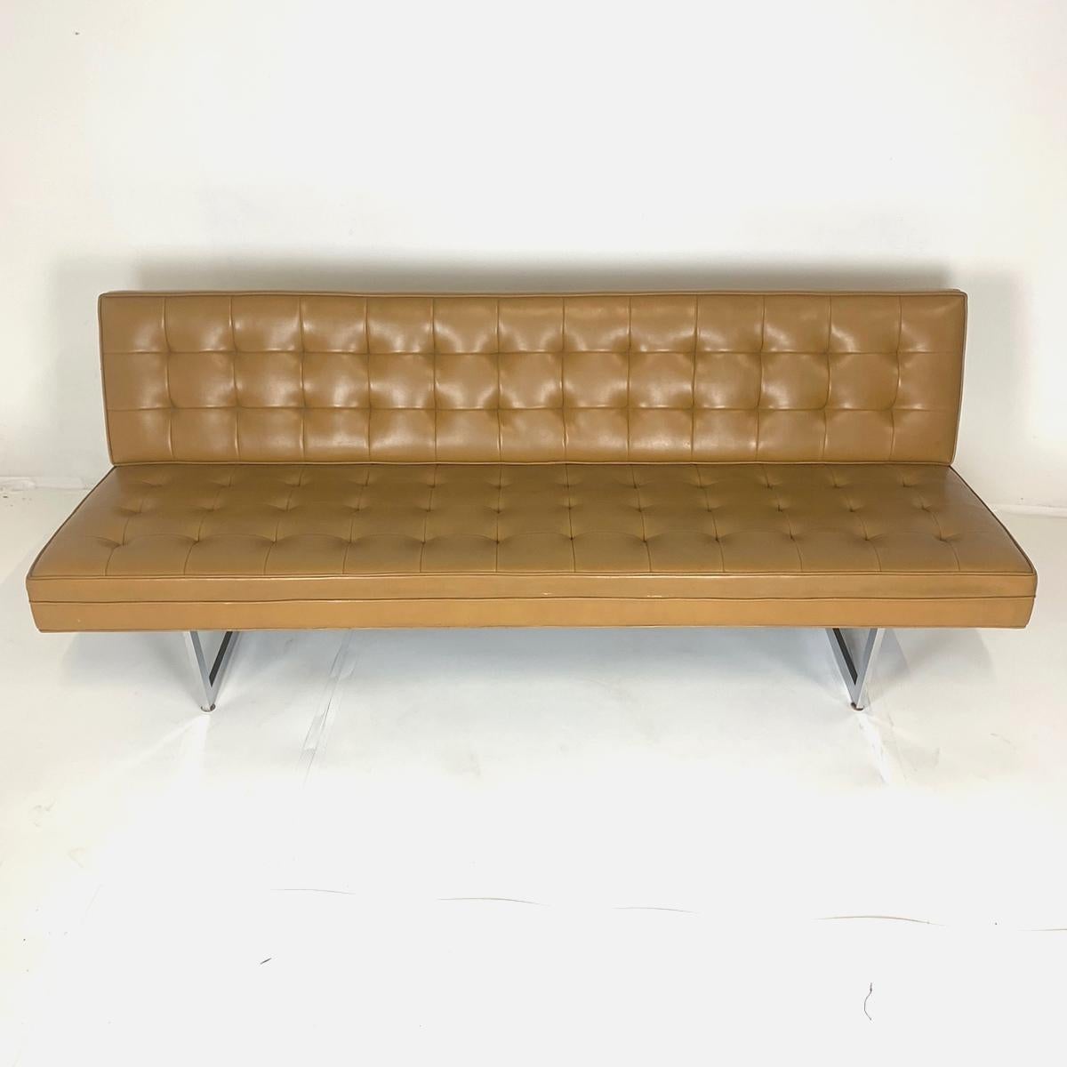 Gorgeous example of Mid-Century Modern in a sleek and sturdy sofa. Great for home, office, or gallery. A luggage or camel colored tufted Naugahyde upholstery with a steel frame. Simply stunning. Made by Patrician Furniture.