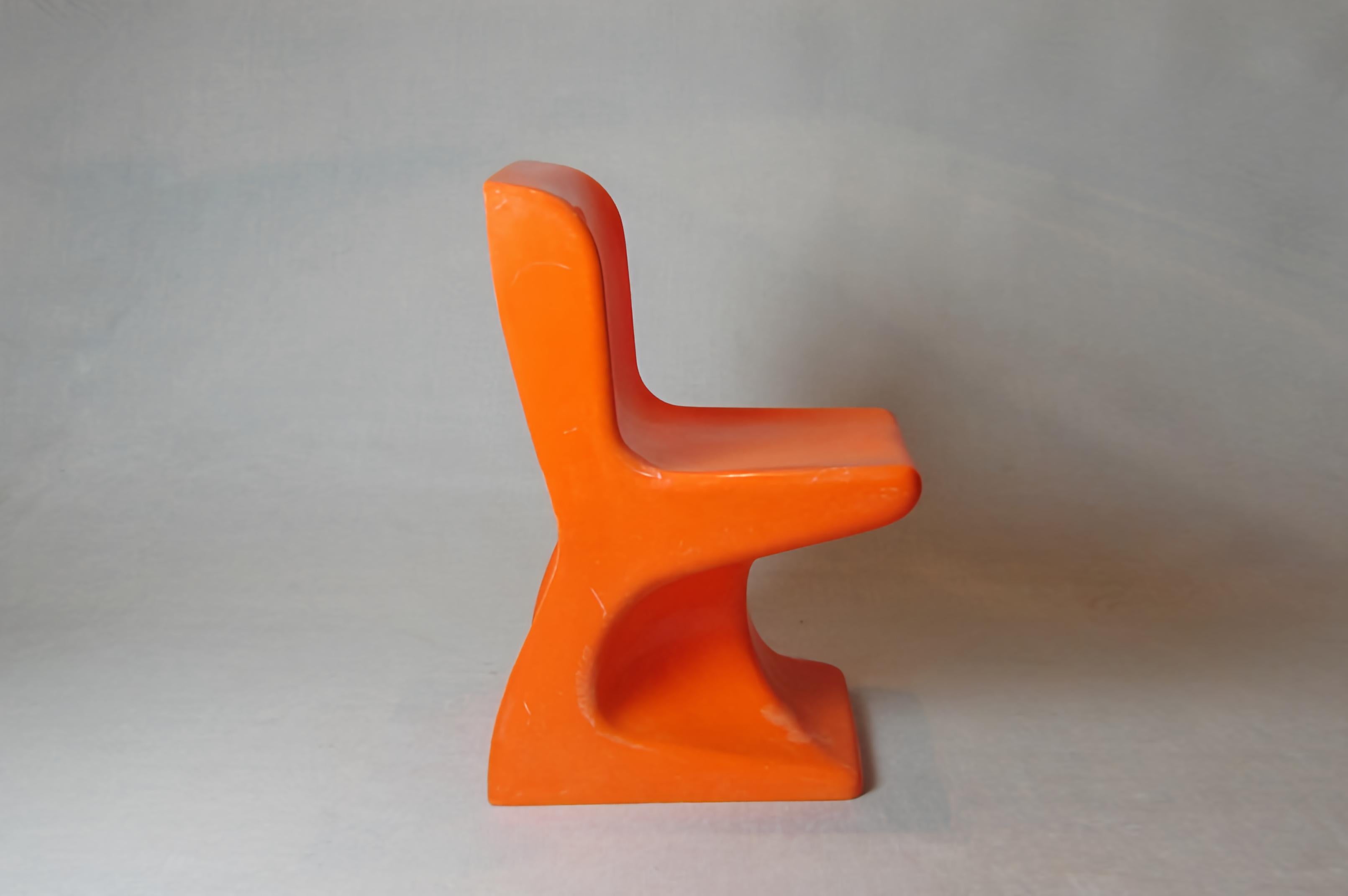 Children's stackable chair designed by Patrick Gingembre for S.E.L.A.P, France 1970. They are made of orange molded plastic with an organic shape that is very characteristic of the Pop and 