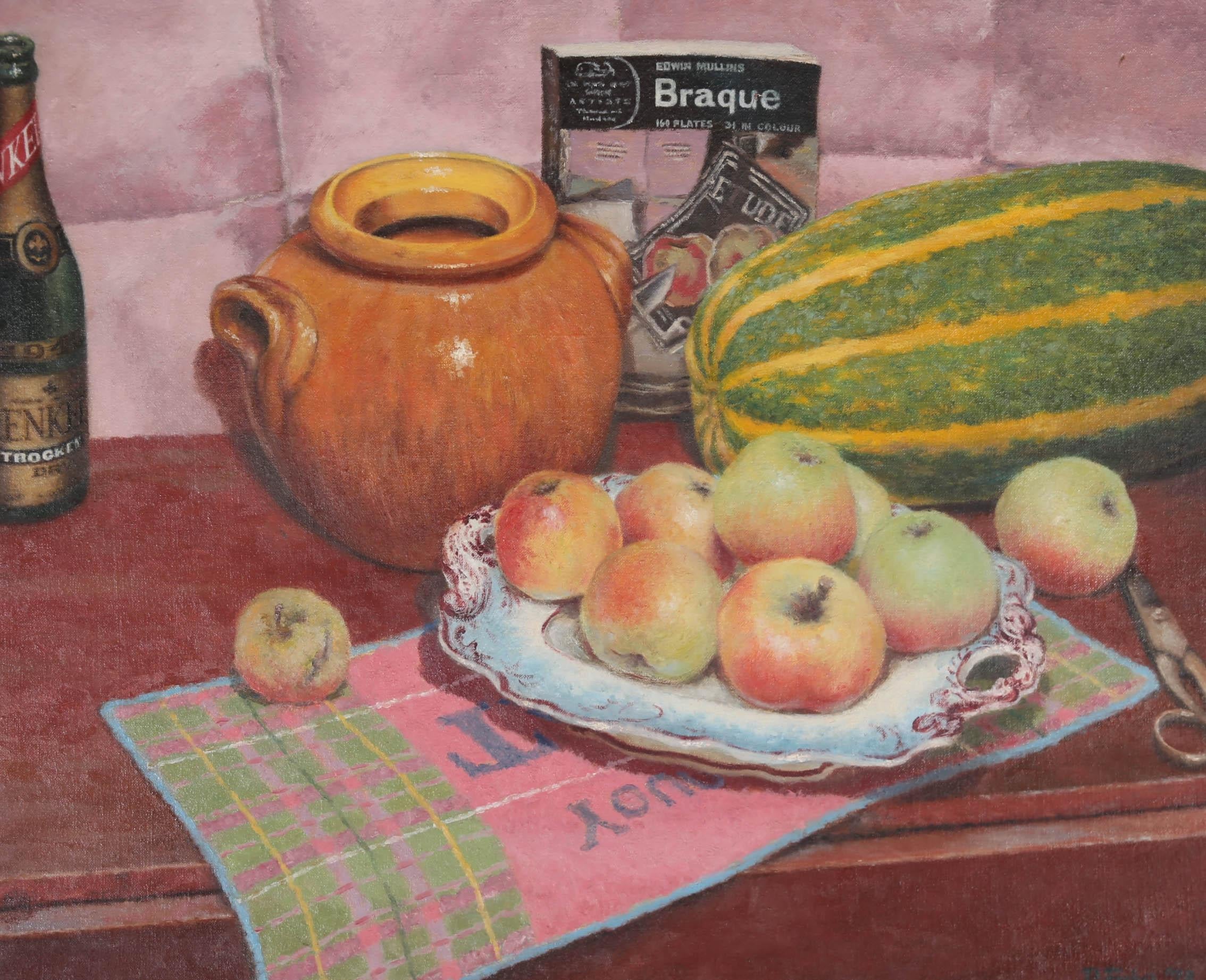 A commercial themed still life composition by Patrick Julian Fisher, depicting a freshly picked plate of apples and a large homegrown marrow on a kitchen counter, next to a Braque cookbook. The painting is signed and dated to the lower right-hand