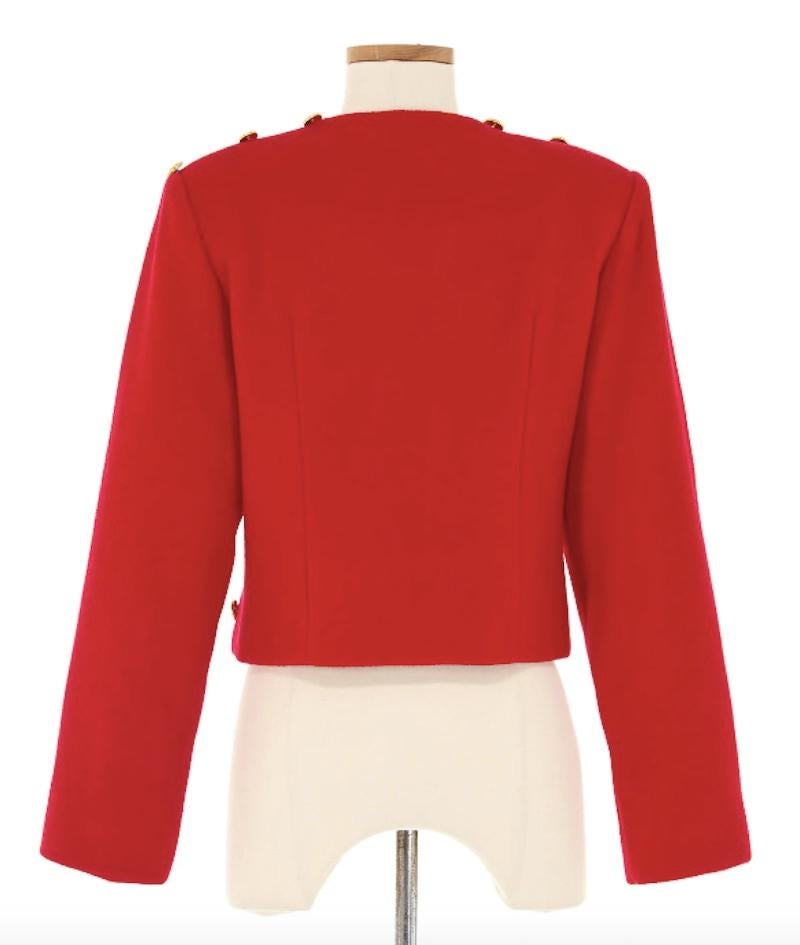 Patrick Kelly Red Jacket with Gold Buttons. This jacket in virbant red is adorned with an array of gleaming gold buttons along the front to create a bold yet sophisticated look. 

Shoulders 18 in
Bust 36 in
Waist 34 in
Sleeve 23.5 in
Length 19