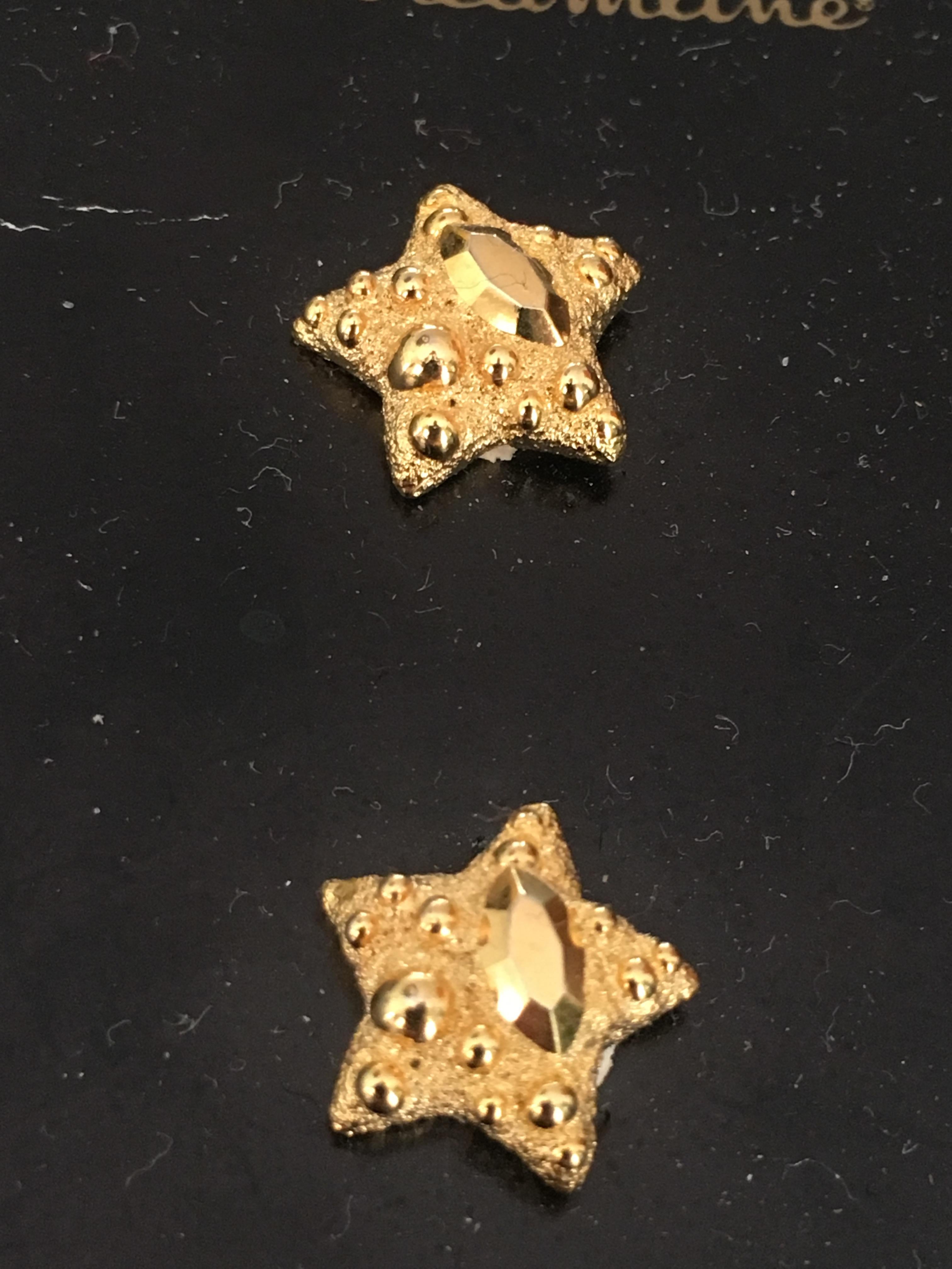 Patrick Kelly Paris Sparkles for Streamline gold star buttons. Use these buttons to update a gorgeous blouse or sweater.  You might even have these repurposed into earrings.  Own a little piece of fashion history.  These are hard to find on the open