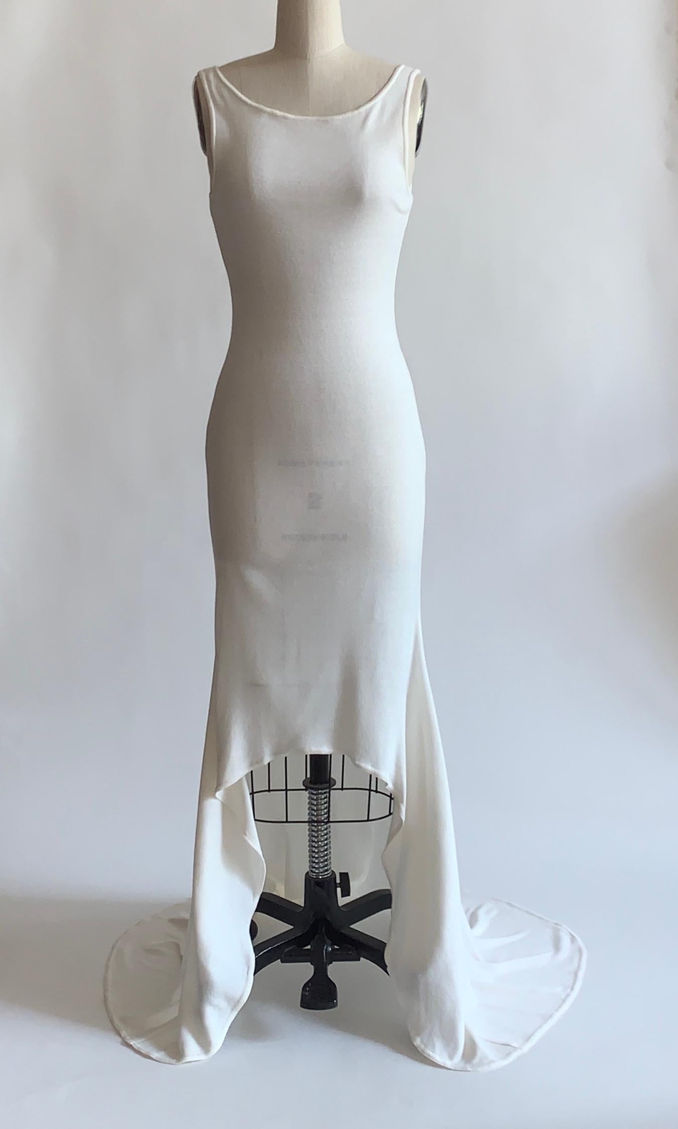 Patrick Kelly vintage 1980s white sleeveless hi-lo knit maxi dress with deep scoop back. Somewhat sheer, works best with nude shape wear or as a pool or swim cover up. Pull-on, no closure. 

No designer or size label, item is a sample from an