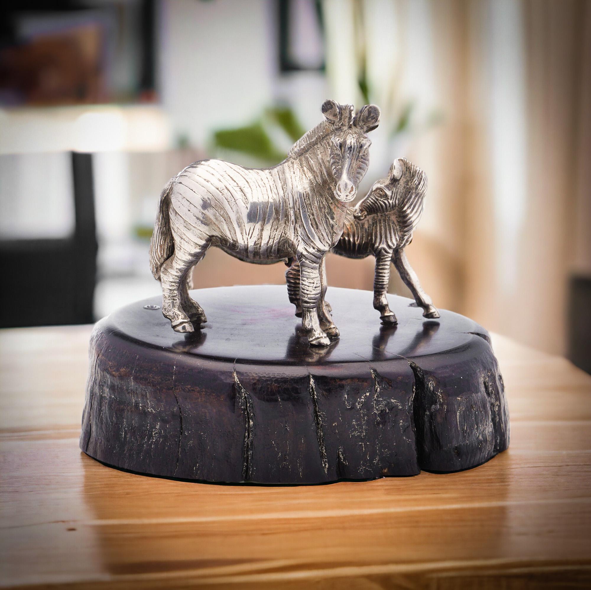 Patrick Mavros 925 sterling silver Zebra and Foal figurine, beautifully crafted and mounted on a stunning blackwood base.
Made in Africa, Zimbabwe, circa 1990s.
Hallmarked with PM mark, Sable antelope head hallmark. 

This unique piece is a