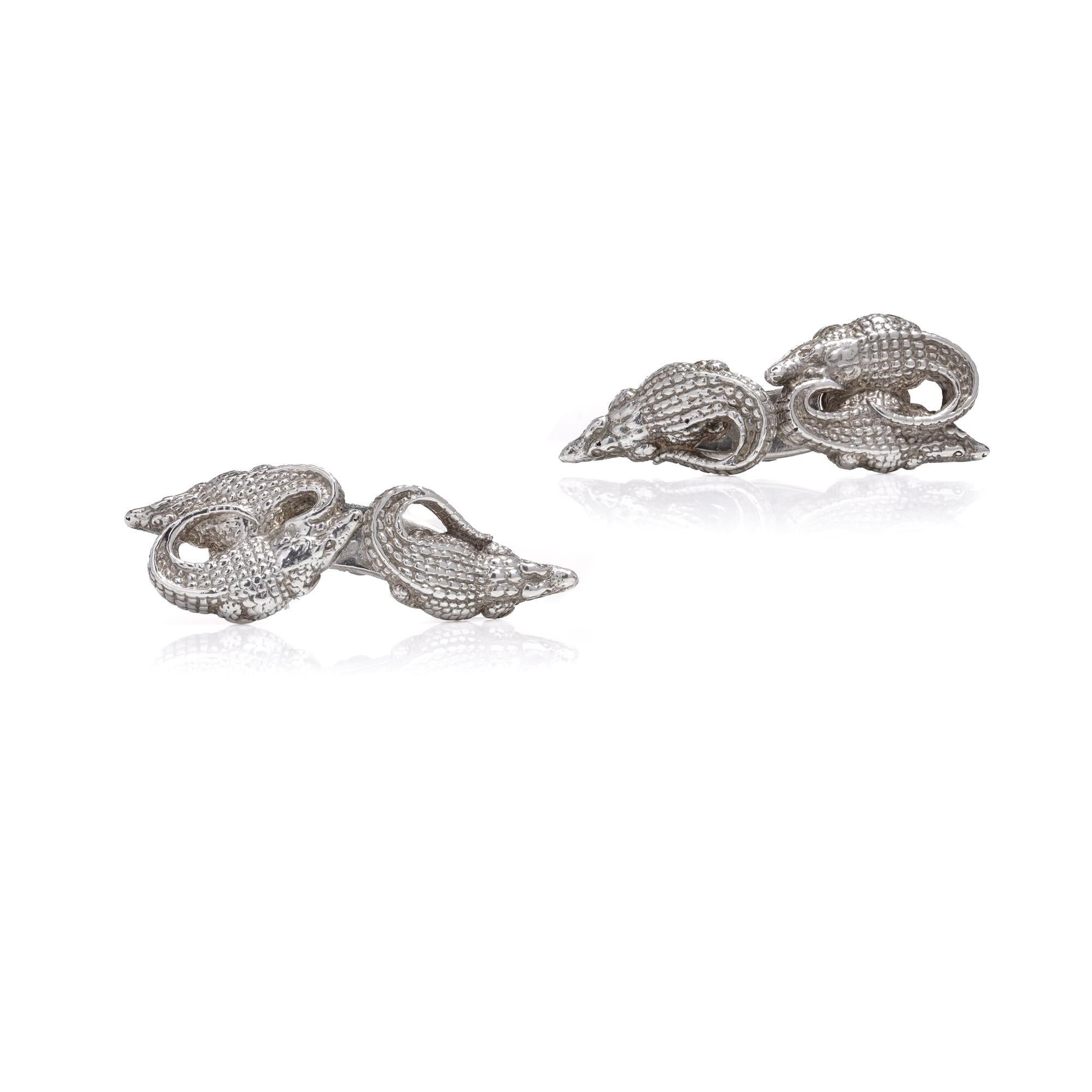 Step into the realm of luxury and adventure with the Patrick Mavros Silver Nile Crocodile Cufflinks. Inspired by the majestic Nile crocodiles, these cufflinks are a tribute to one of Africa's most iconic and formidable creatures.

Crafted from solid
