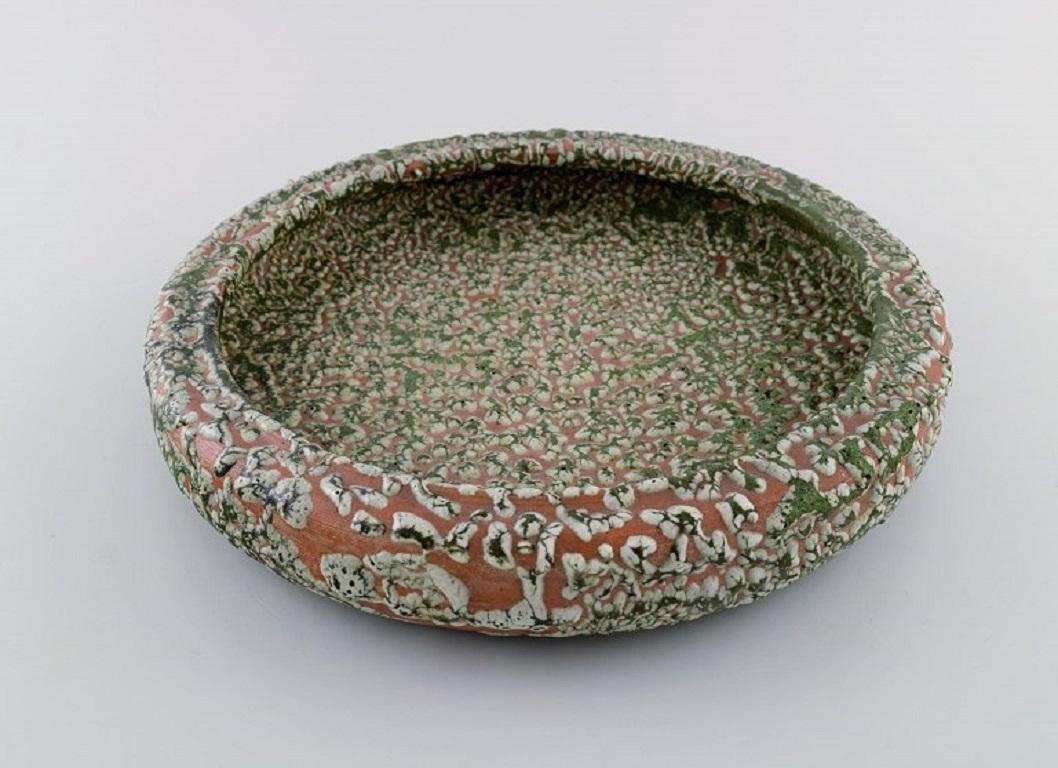 Patrick Nordström (1870-1929). Unique dish / bowl in glazed ceramics. 
Islev, own workshop. Beautiful and unusual speckled glaze. Dated 1928.
Measures: 26.5 x 5 cm.
In excellent condition.
Signed and dated.
