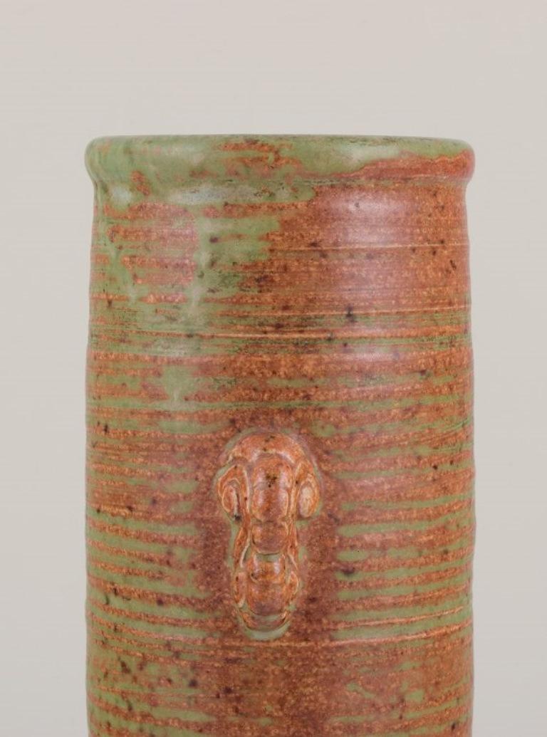 Patrick Nordström (1870-1929) for Isle, Denmark.
Large cylindrical ceramic vase.
Glaze in shades of green and brown.
Signed and dated 1924.
In perfect condition.
Dimensions: Height 25.6 cm. x width 9.5 cm.
Provenance: Private Danish ceramics