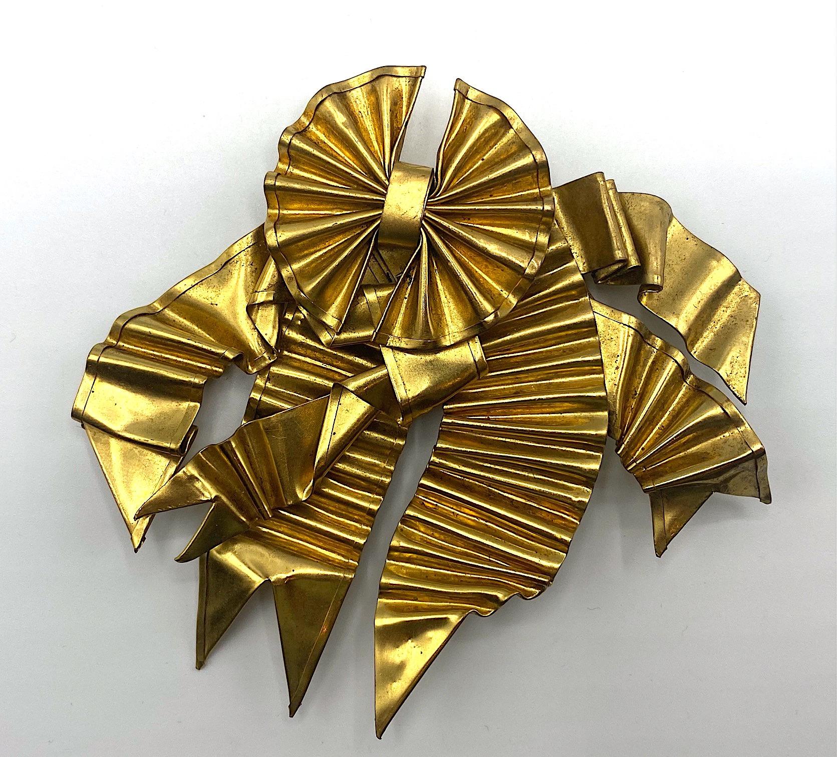 An exceptional and rare 1980s large brooch by important French jewelry designer Patrick Retif (1958 - 1991). It is hand made of folded metal ribbons and gold plated. The brooch is 4.25 inches wide, 4 inches long and .5 of an inch deep. The back has