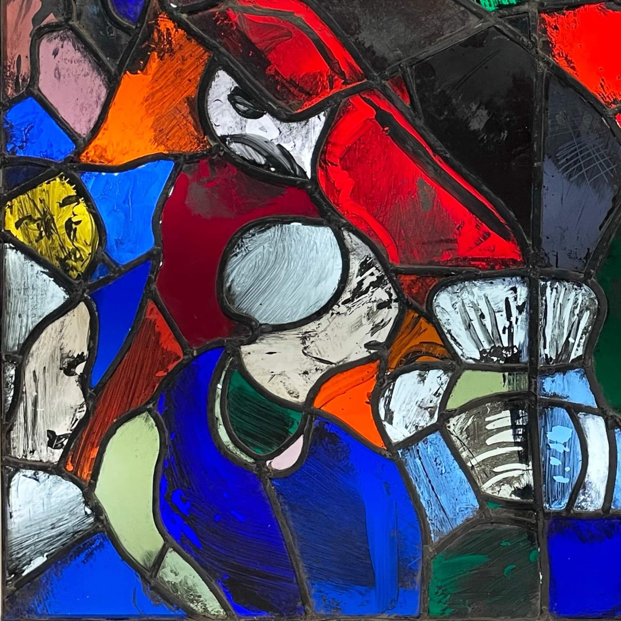An abstract stained glass window from the studio of Patrick Reyntiens (1925-2021). Attributed to the artist, this stained glass panel depicts a colourful design with abstract hand painted details and irregular forms. It is one of various stained