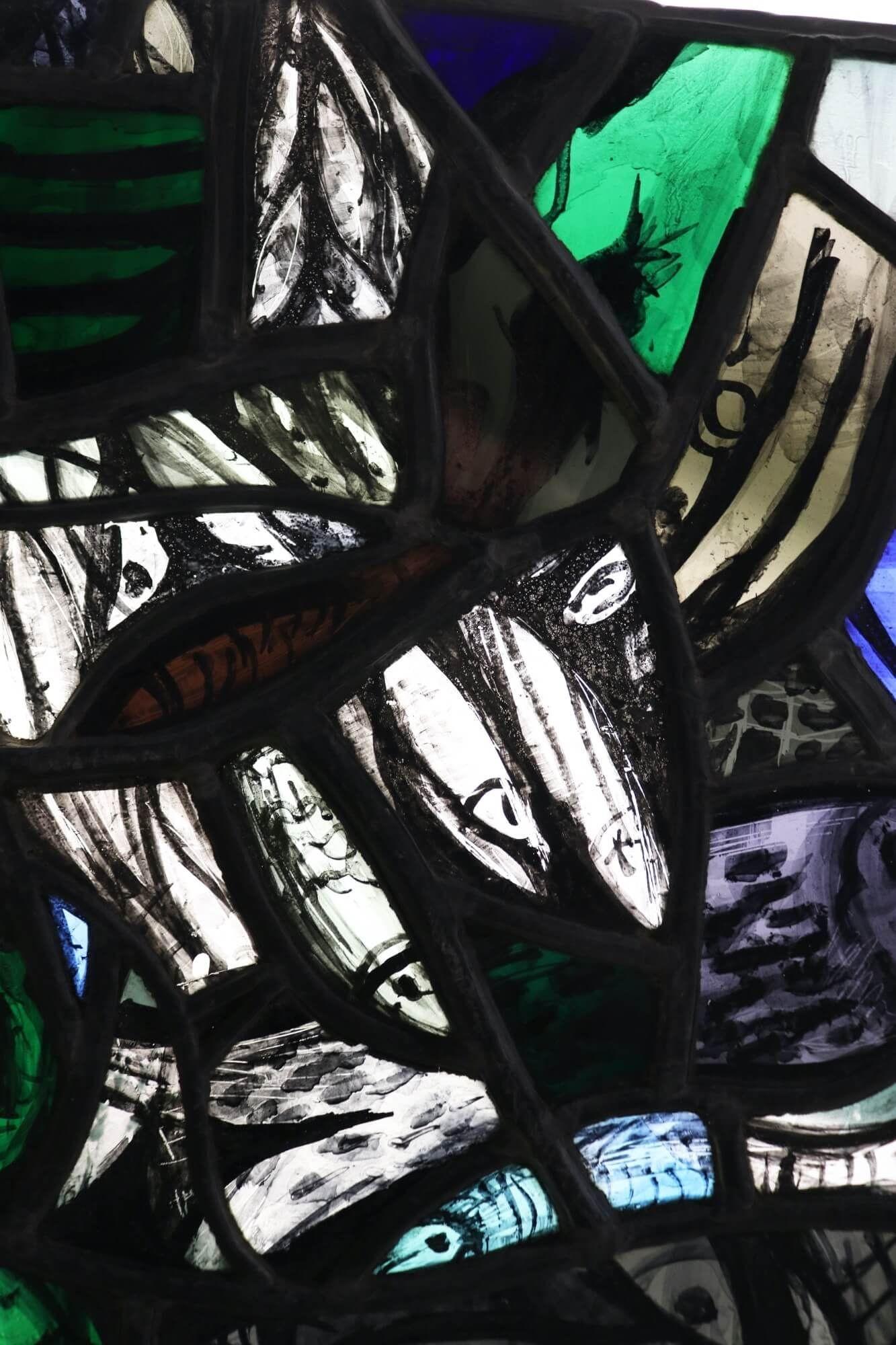 A contemporary stained glass window from the studio of Patrick Reyntiens (1925-2021). Attributed to the artist, this stained glass panel depicts what appears to be net or school of fish, possibly influenced by John Piper, with hand painted