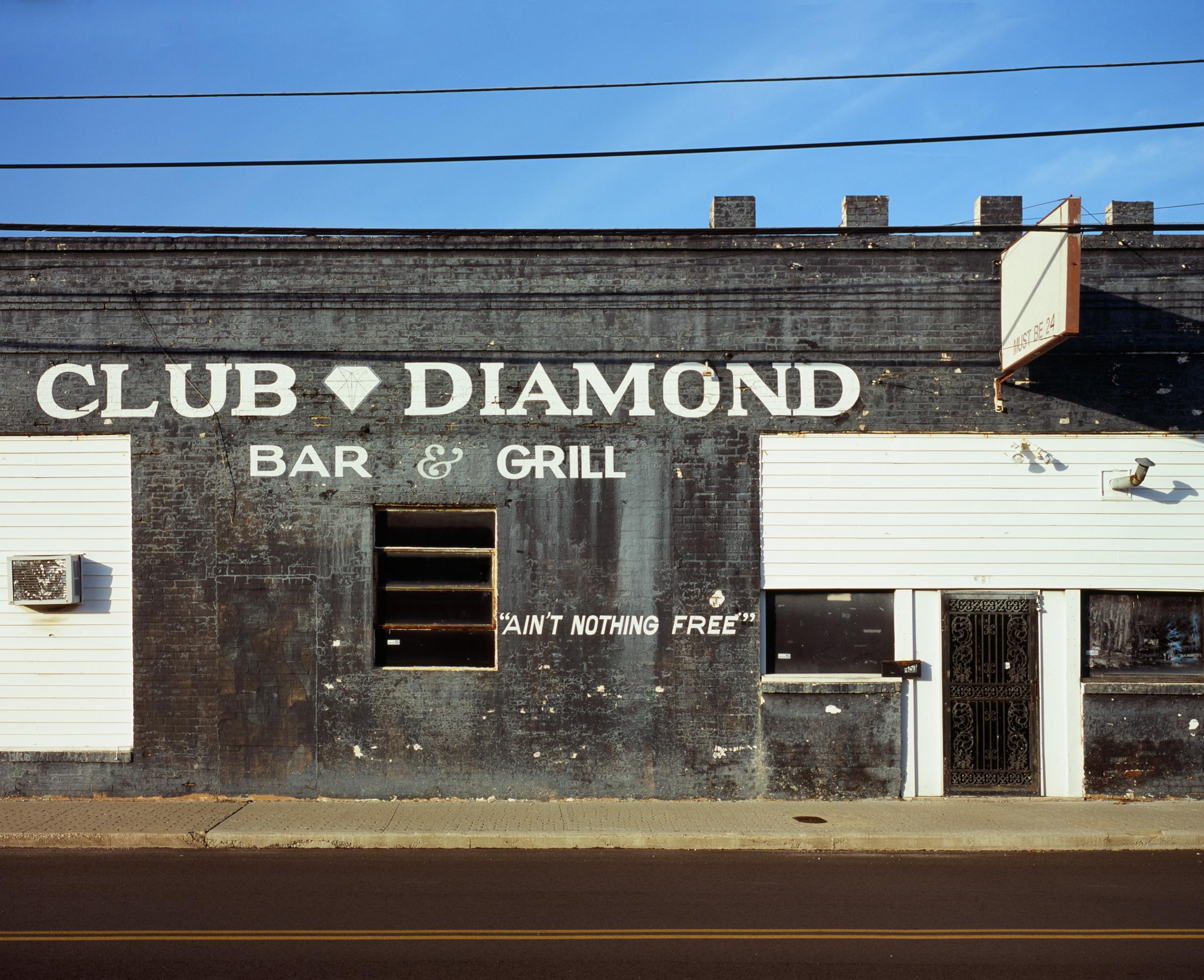 Patrick Sansone uses analog cameras and film to create photographs that reference stillness, lure, and intermission. Decaying signage, abandoned industrial sites, and defunct storefronts are the artifacts of a near-mythic America, now abandoned.