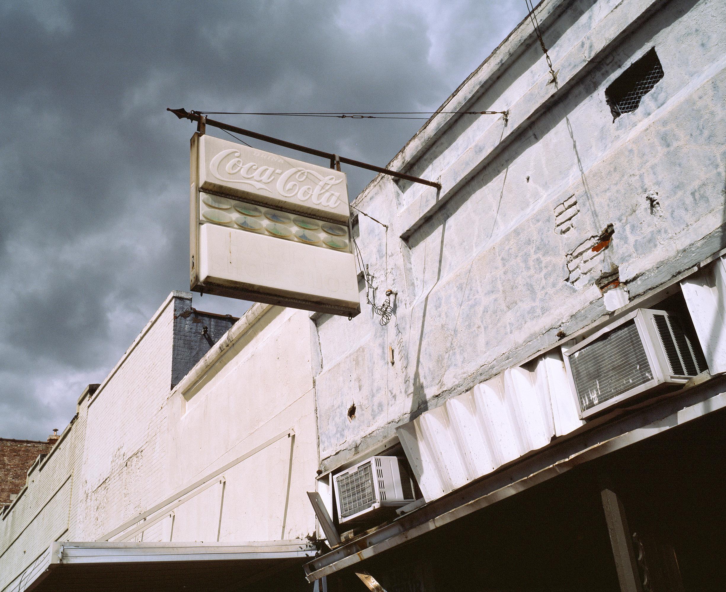 Patrick Sansone uses analog cameras and film to create photographs that reference stillness, lure, and intermission. Decaying signage, abandoned industrial sites, and defunct storefronts are the artifacts of a near-mythic America, now abandoned.