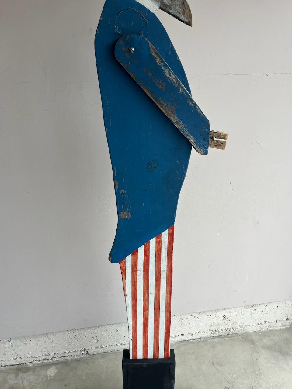 Handmade and painted Uncle Sam in all original painted surface.We made a wood block stand for the carved Uncle Sam folky sign.