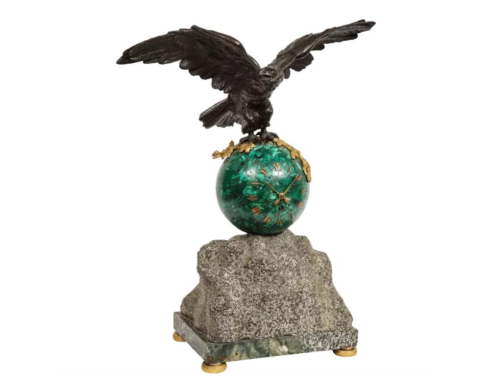 Patriotic French patinated bronze eagle and malachite clock on granite base, 1889.

Very nice clock with patinated bronze flying eagle sitting on a round malachite globe-form clock.

Unique piece. Clock with Roman numeral numbers sitting on a